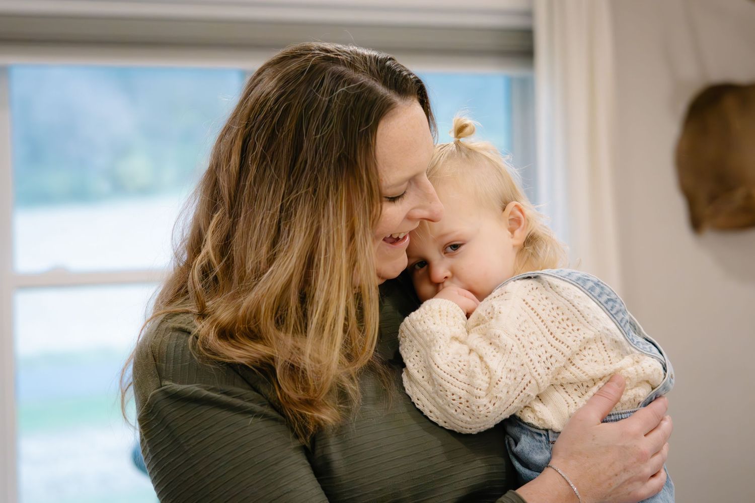 Tender family moments captured in a series of intimate indoor portraits showing affection and connection.