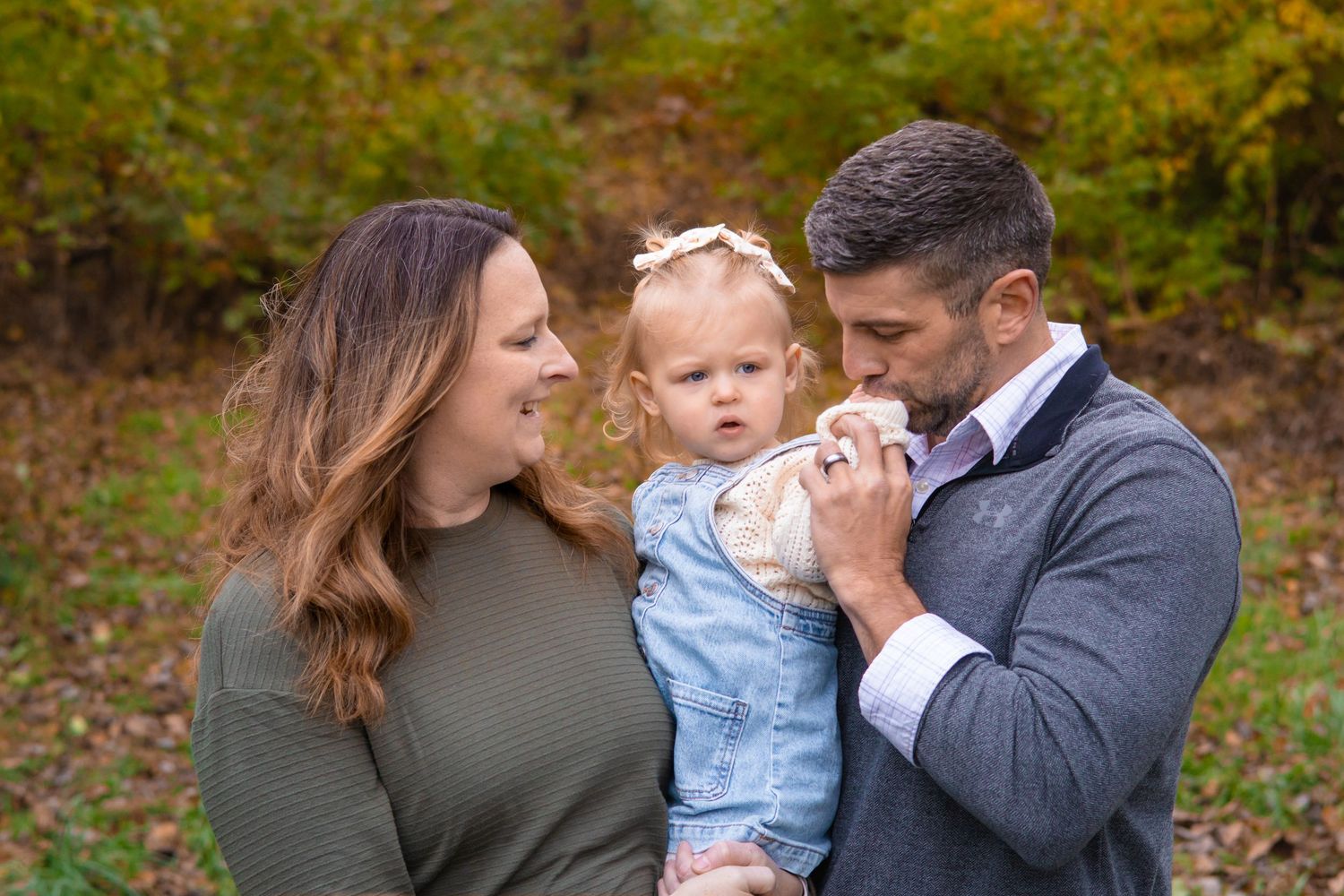 Family sharing emotional moments together in an autumn forest setting.