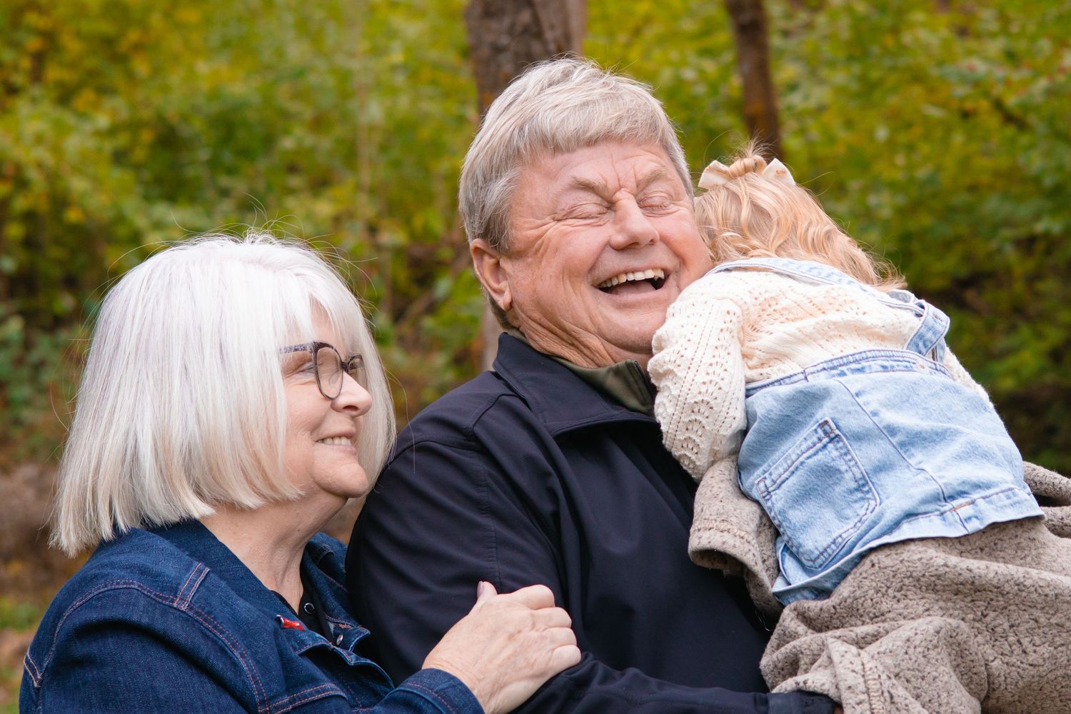 Candid family moments shared between generations in a natural outdoor setting.