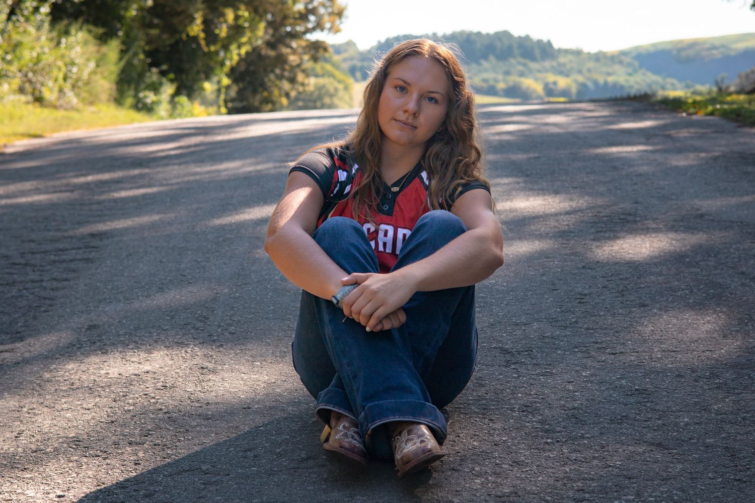 Artistic portrait series taken on a scenic mountain road at golden hour.