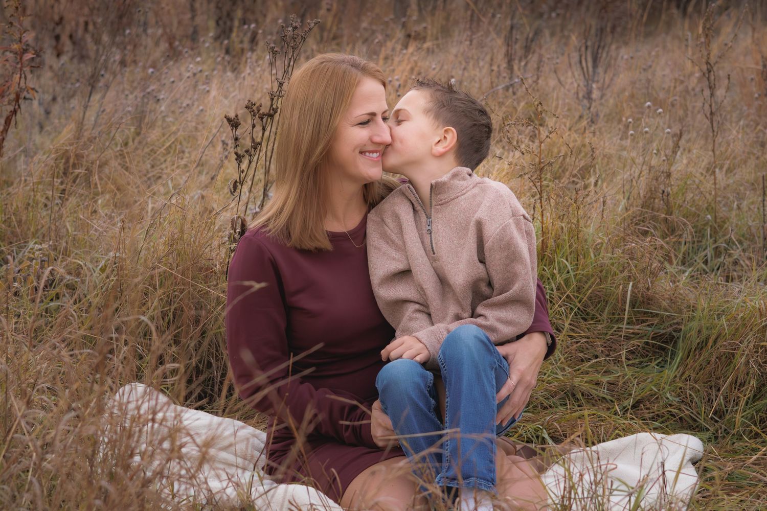 Family sharing intimate moments together in a rustic autumn field.
