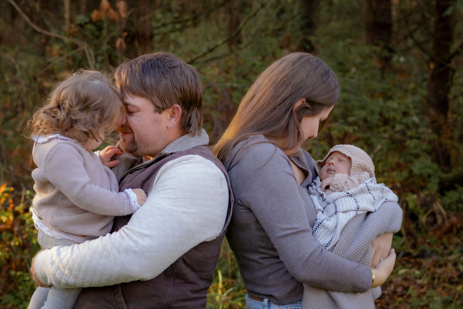 Group hugging and embracing during outdoor autumn photo session.