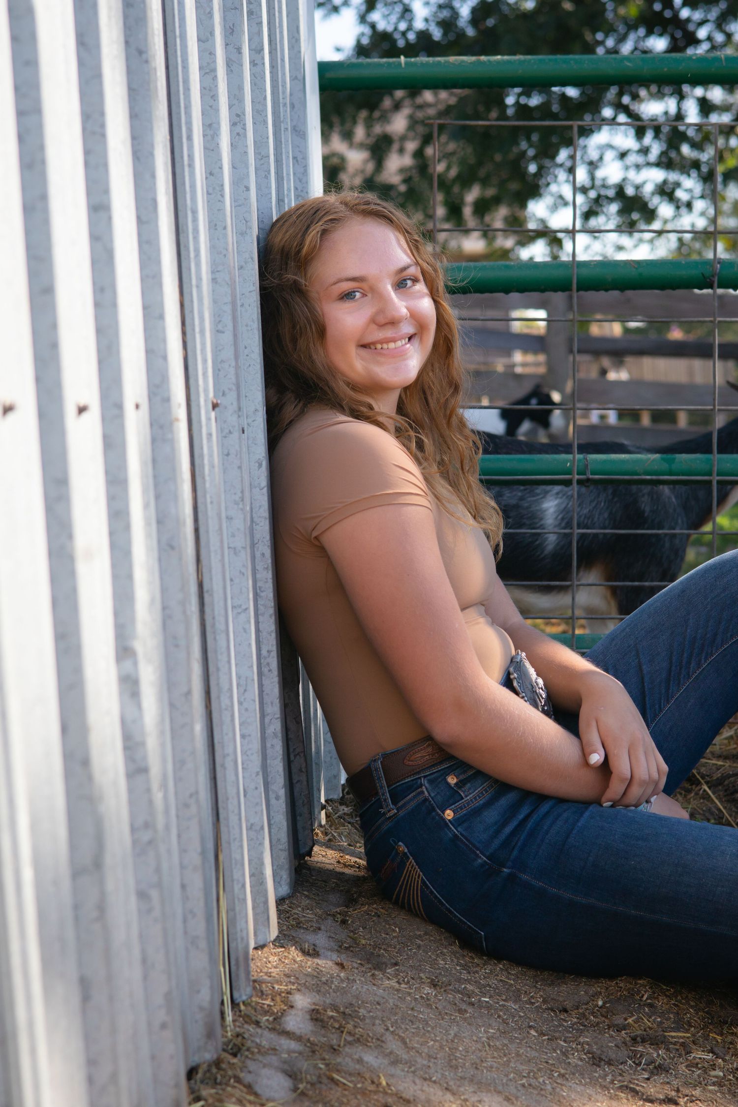 Casual portrait session against corrugated metal wall background.