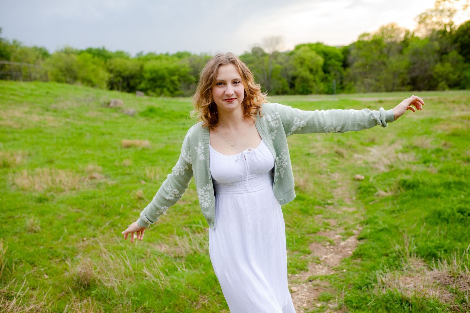 A series of photos showing someone in a white dress twirling joyfully in a sunlit green meadow on a spring day.