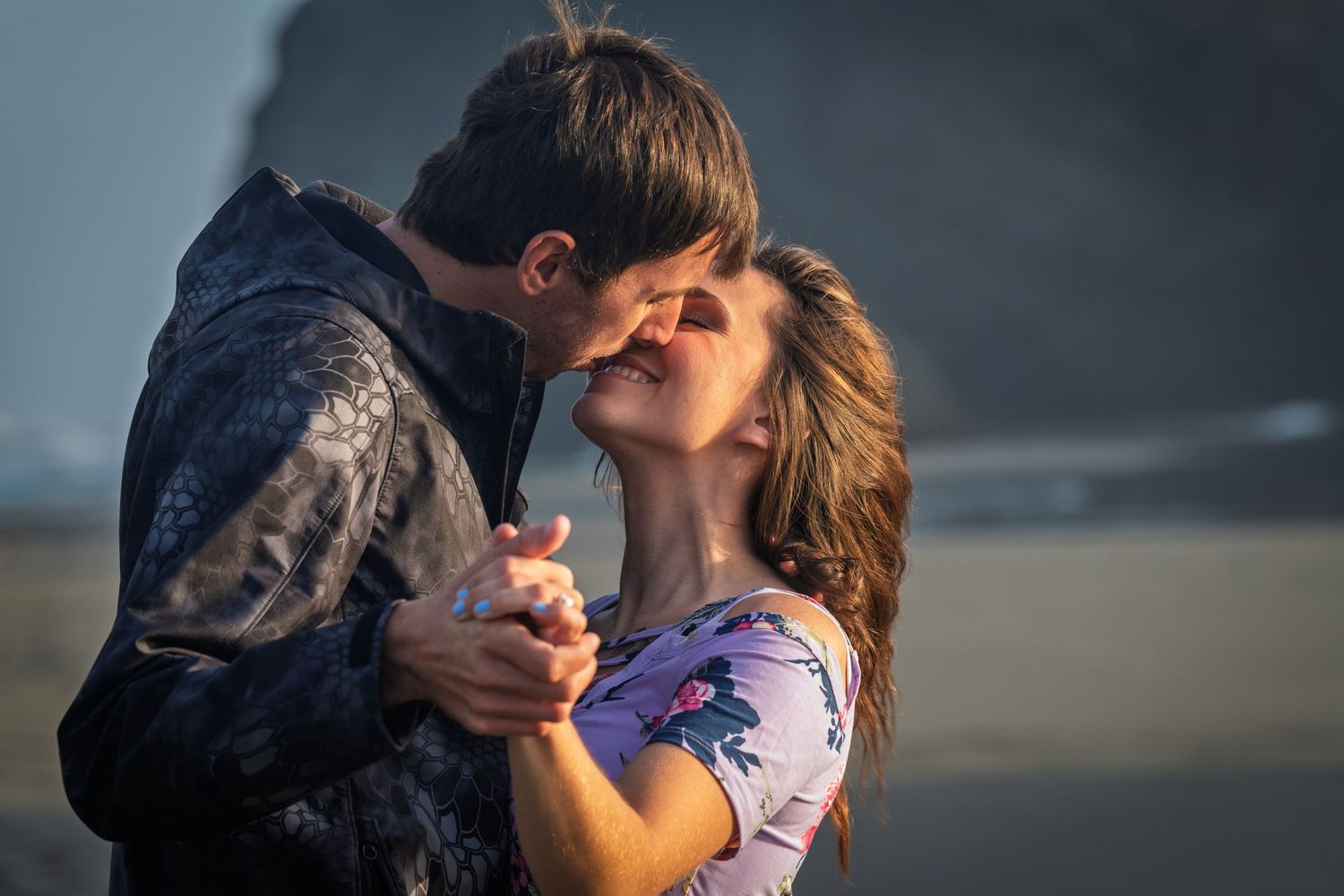 Romantic couple embraces and kisses on a beach during sunset with multiple frames showing their intimate moments.