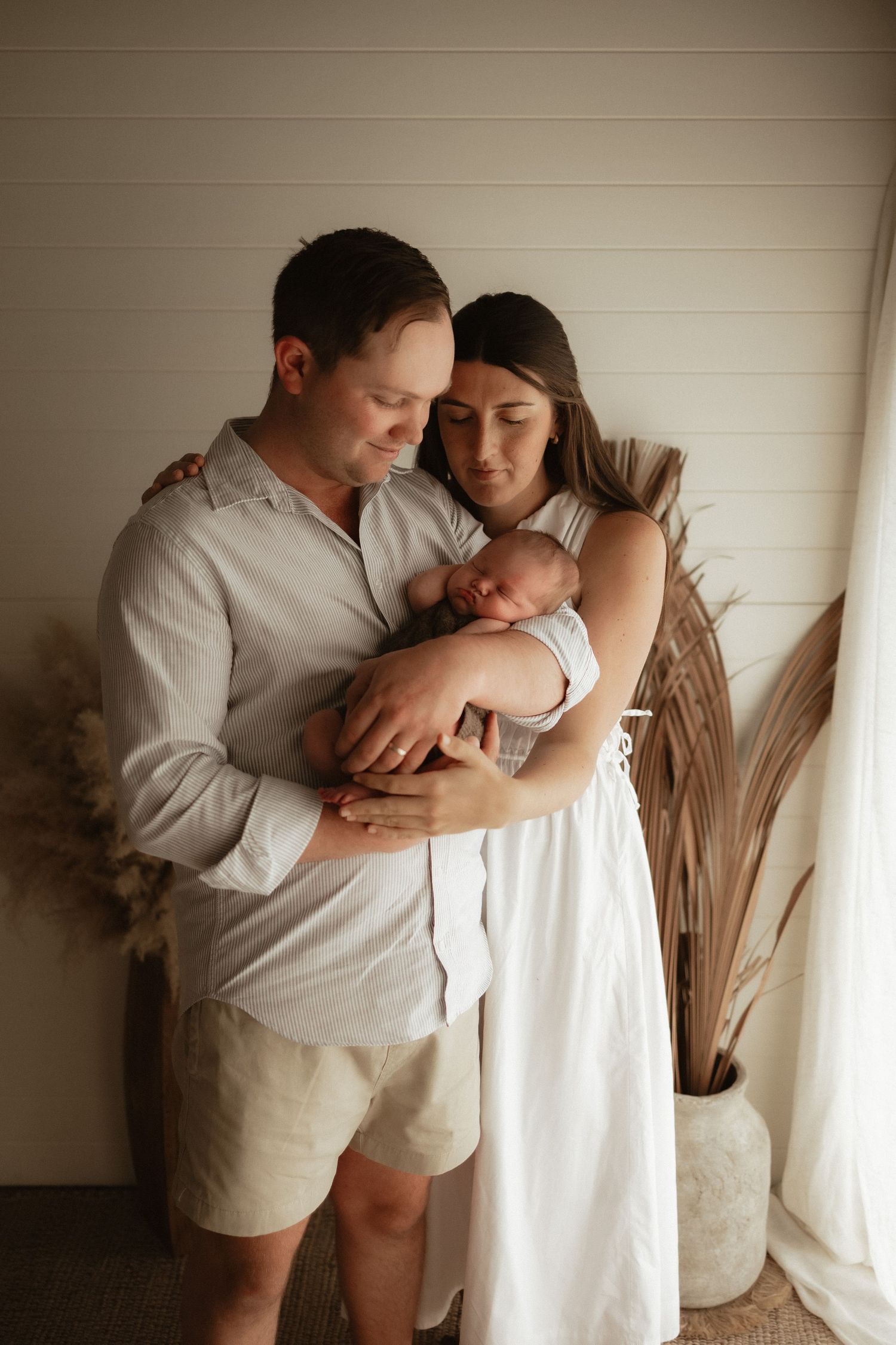 mum and dad newborn photos soft natural light, emotive and warm brown