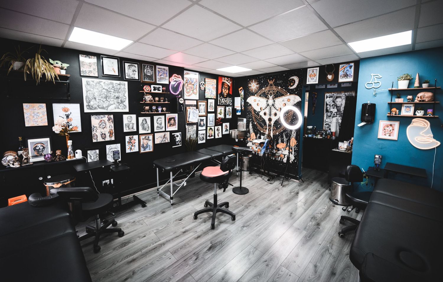 Modern studio space with hardwood floors and walls covered in black and white photographs.