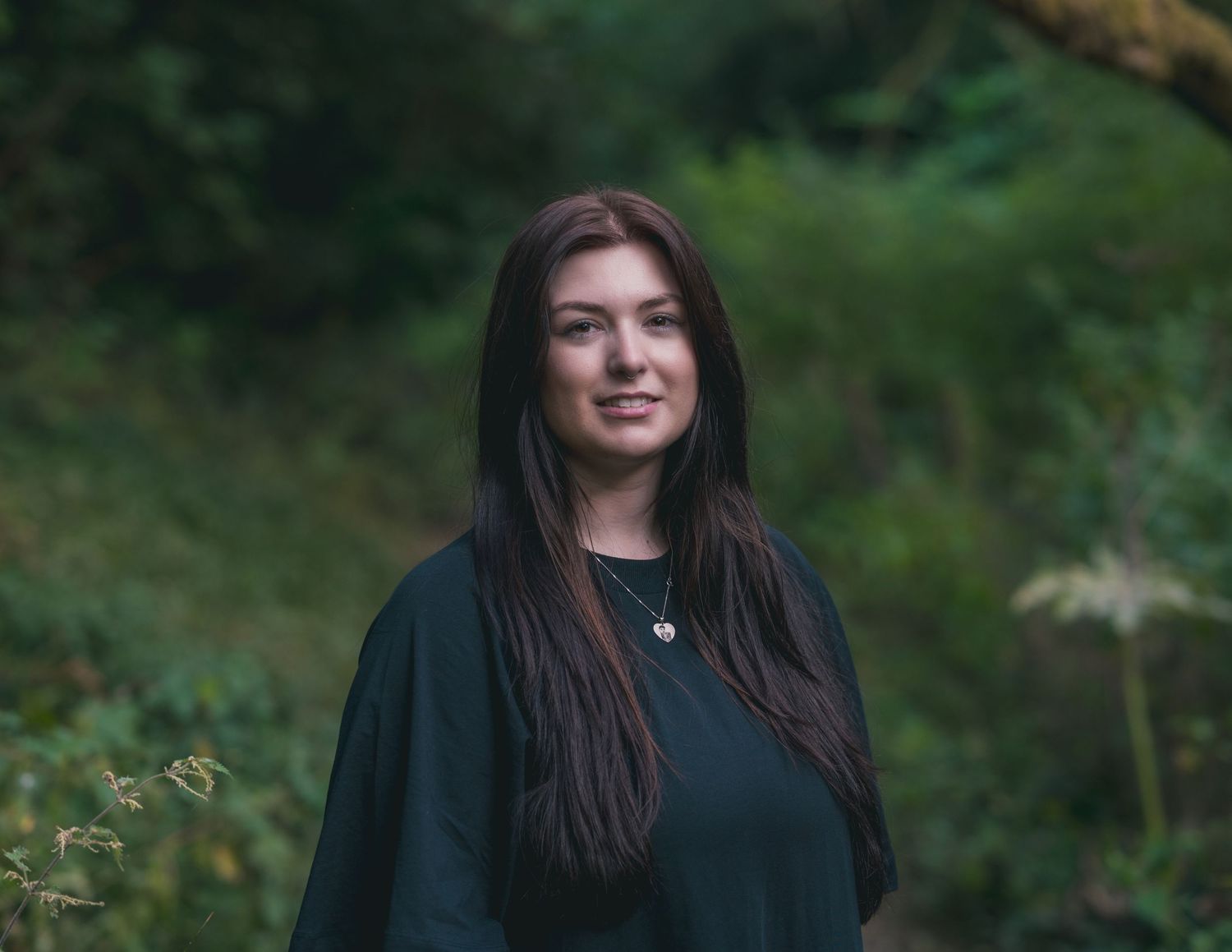 An outdoor photography session featuring candid moments against green foliage.