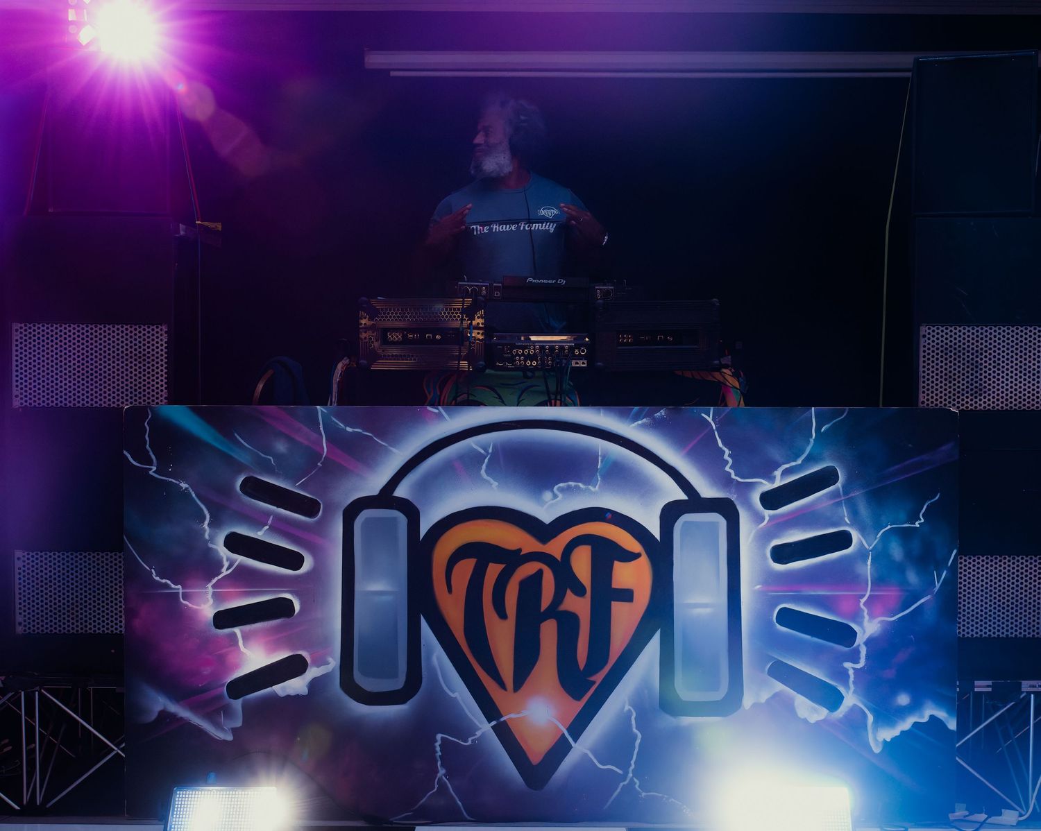 Purple and blue lightning effects with club logo design in dark atmospheric setting.