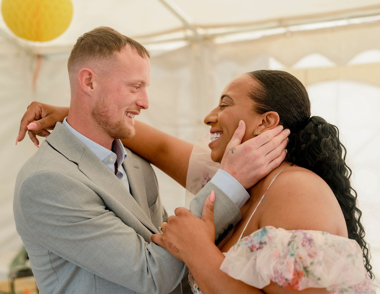 Newlywed couple embracing lovingly at wedding celebration.