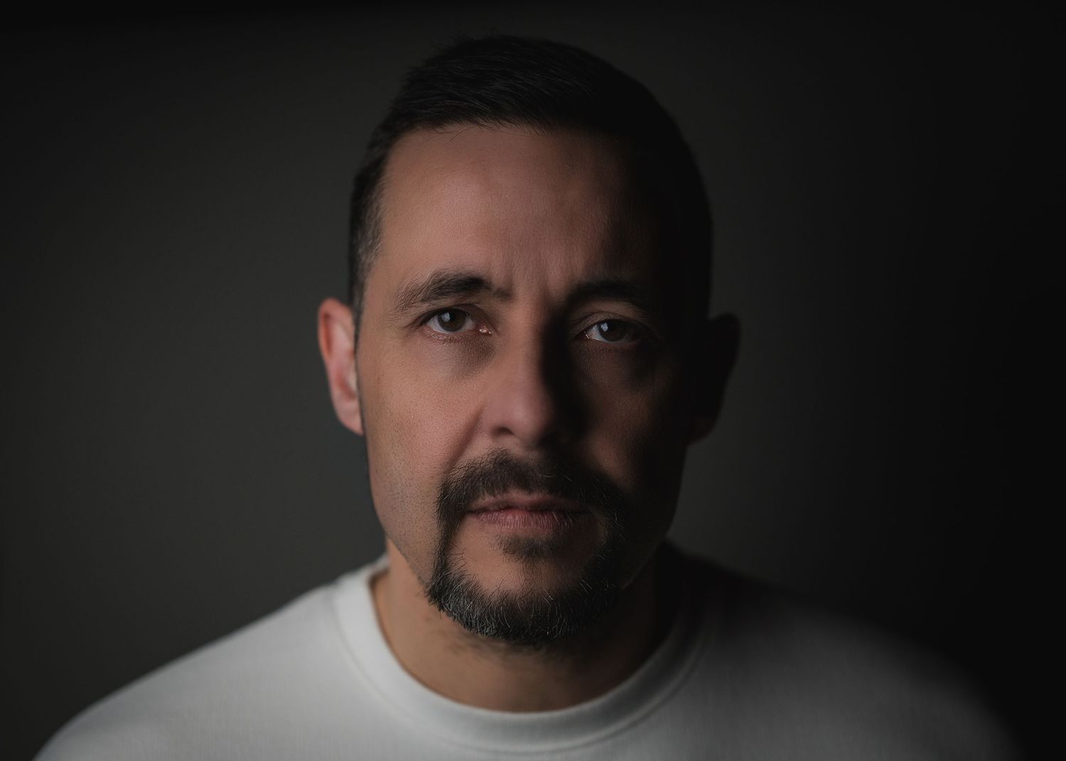 Black and white dramatic headshot portraits showing different lighting angles on dark background.