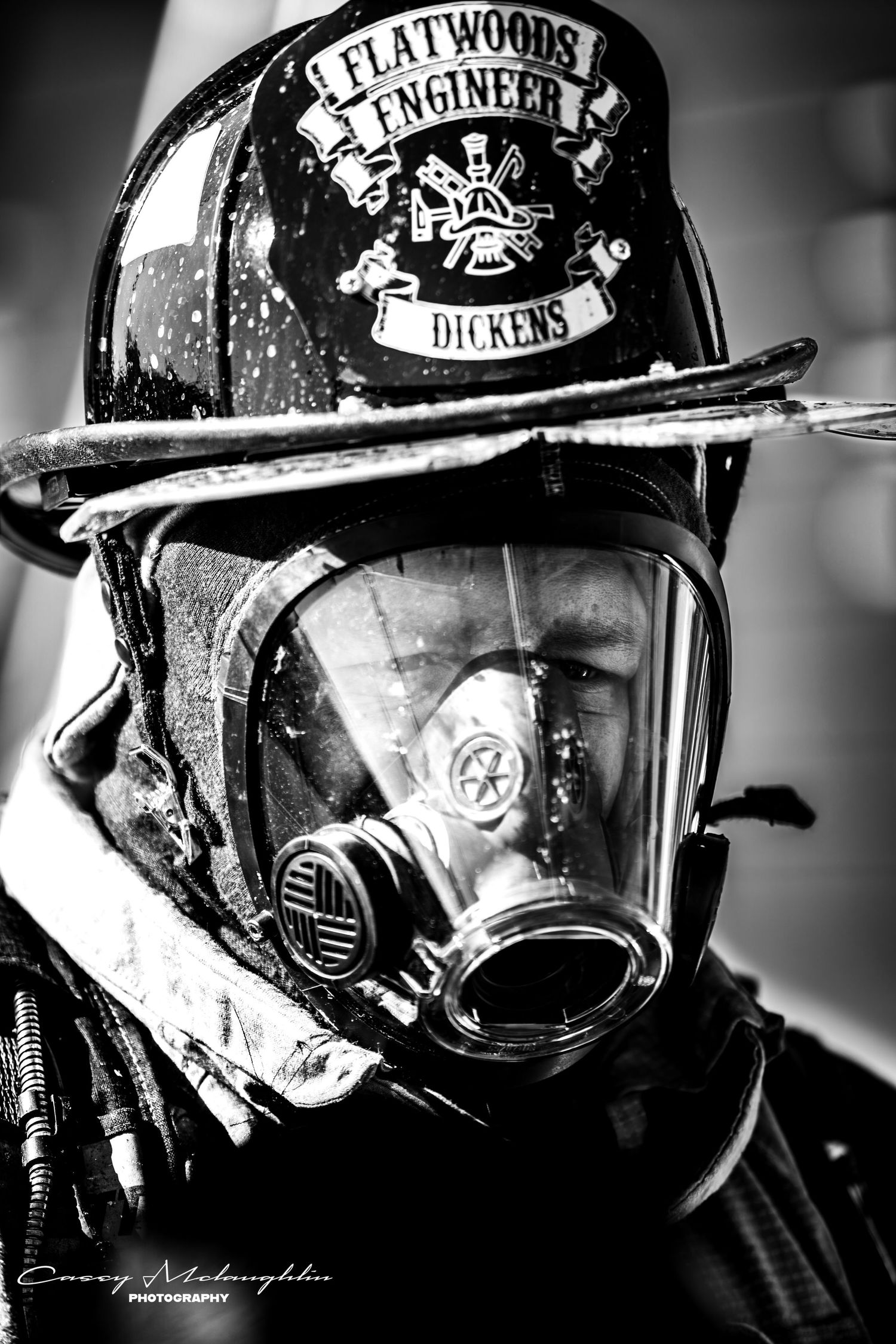 Black and white close-up photos of firefighter helmets and breathing apparatus masks in a dramatic style.