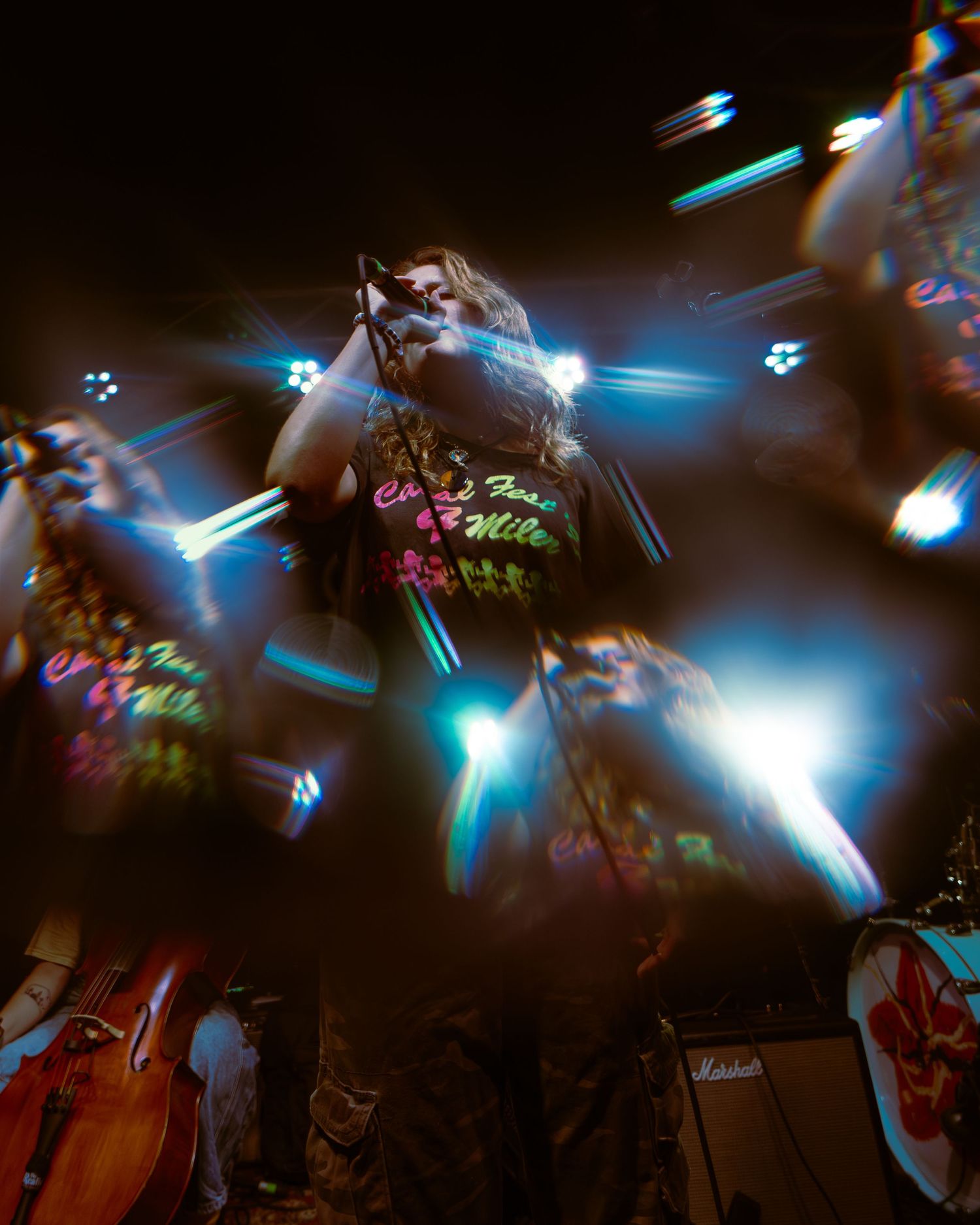 A concert performance with colorful stage lighting and motion blur effects creating a dynamic atmosphere.