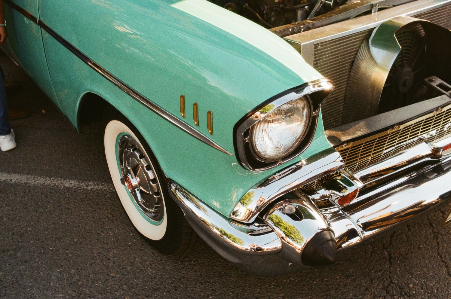 Detail shots of a mint green classic car's chrome trim and bodywork.