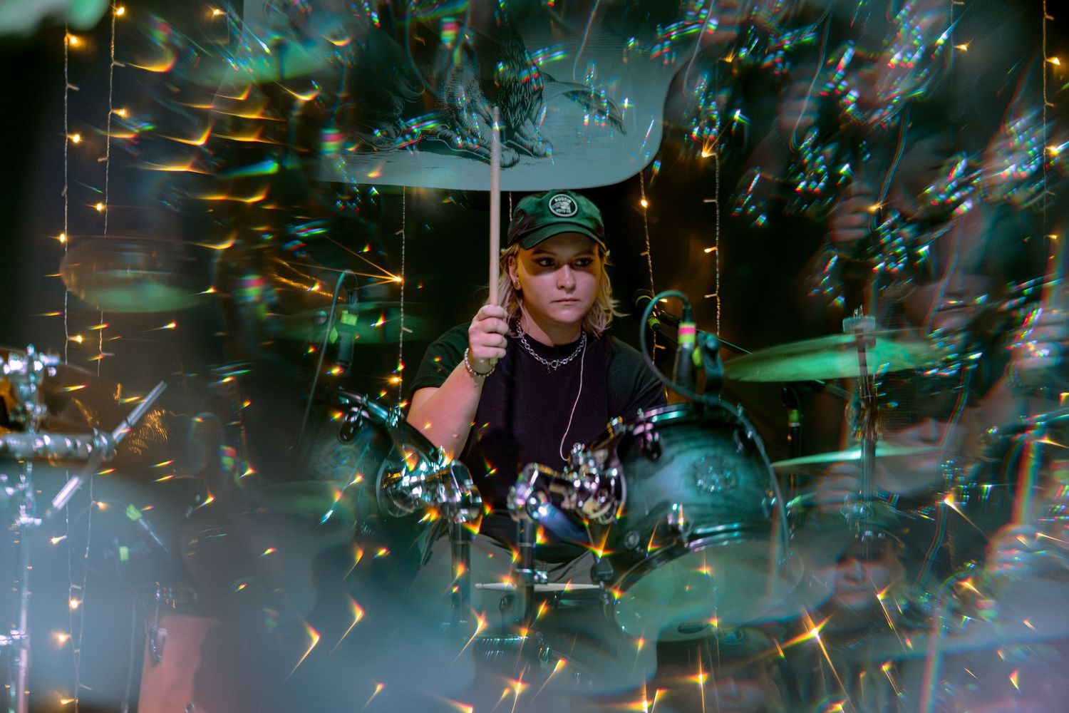 Live concert performance with sparks of golden light and smoke effects illuminating the darkened stage.