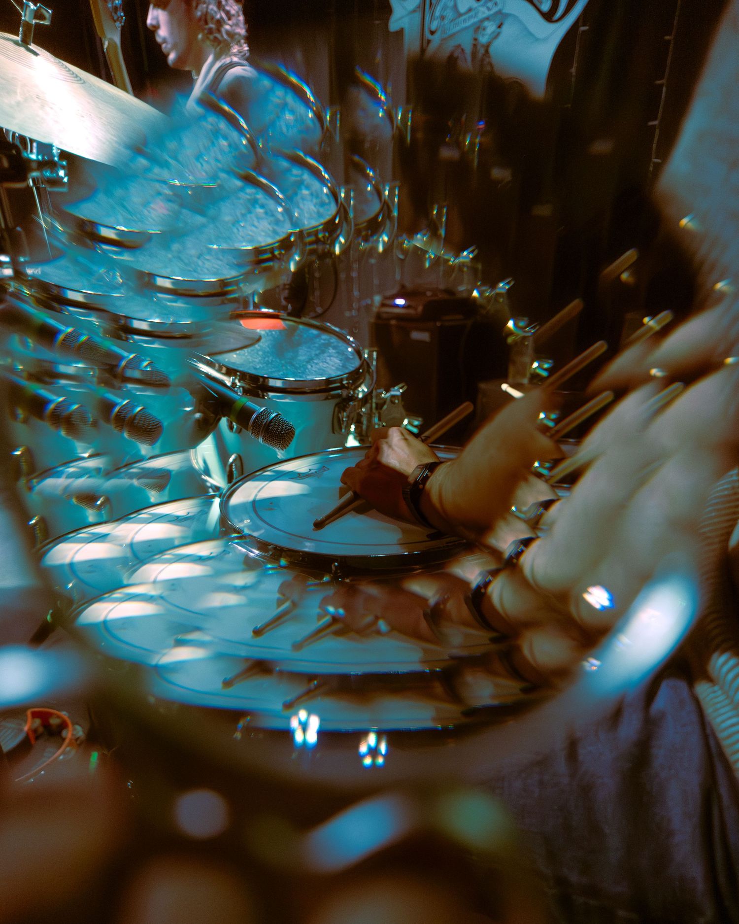 A moody artsy close-up of wine glasses with blue lighting creating a dramatic abstract effect.
