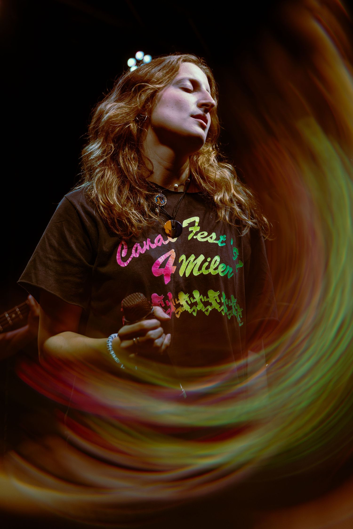A progressive series of close-up photos showing a swirling light effect in warm tones with an illuminated figure in darkness.