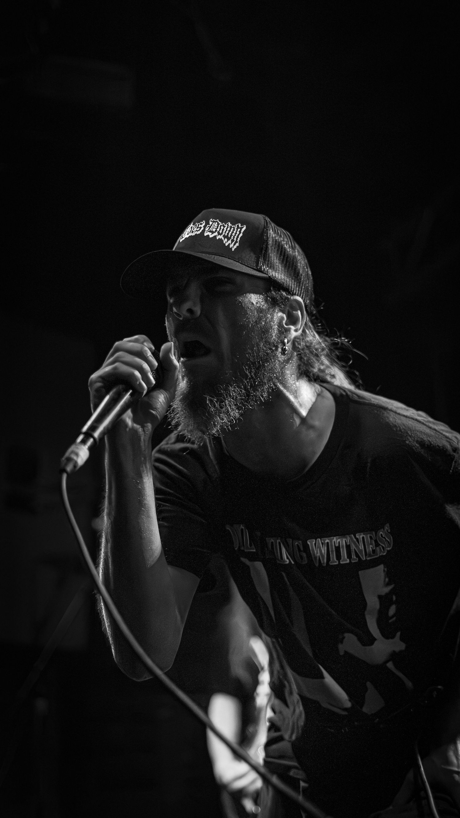 Black and white performance photos of vocalist on stage during a live music show.
