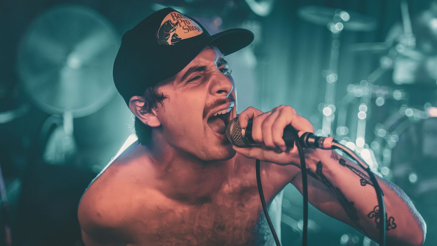 Concert performance captured in close-up shots under bright stage lighting.