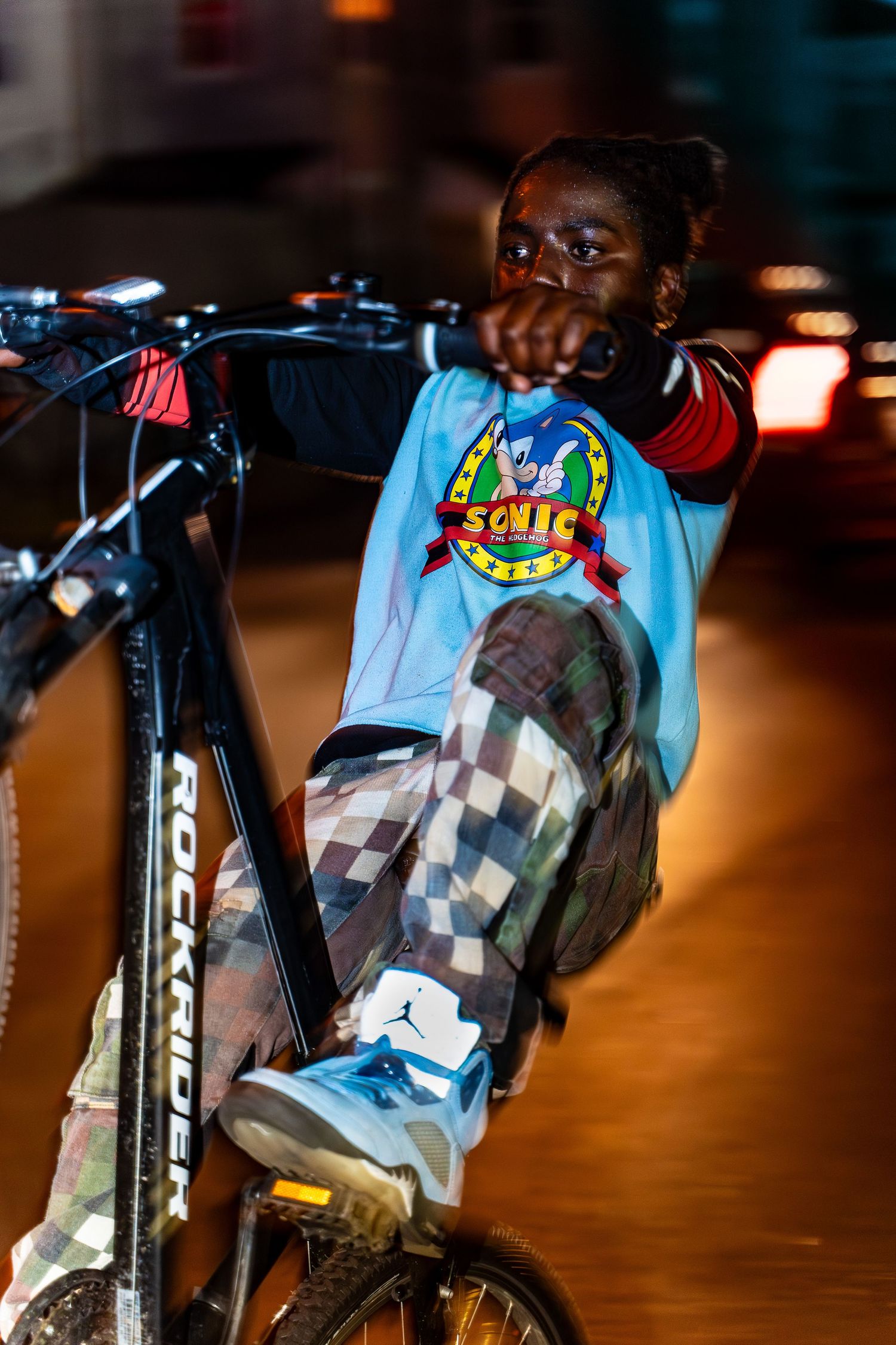 Close-up details of a BMX bike with colorful stickers and checkered pattern designs.