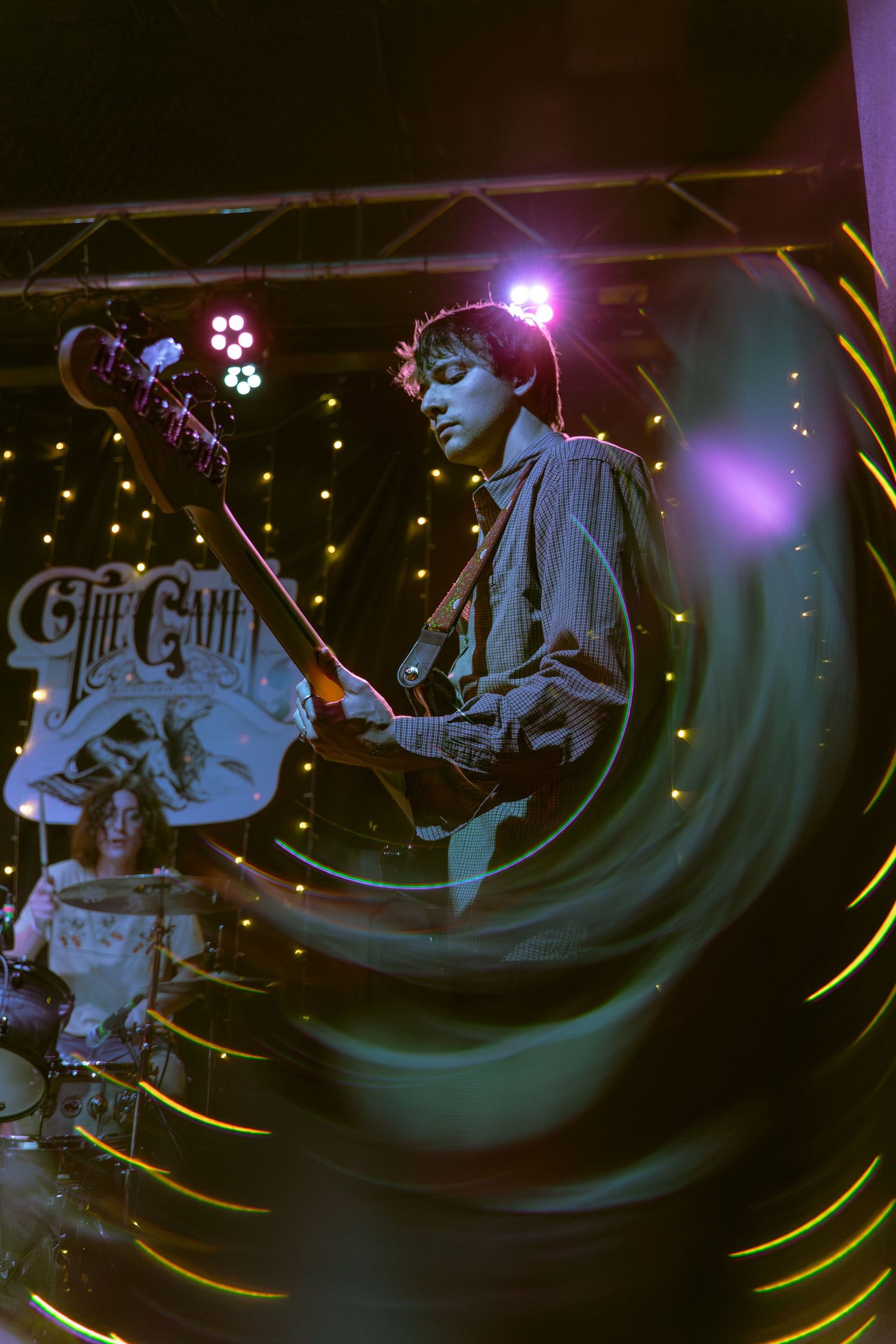 A sequence of dark atmospheric concert photos with swirling blue lights and silhouettes performing on stage.