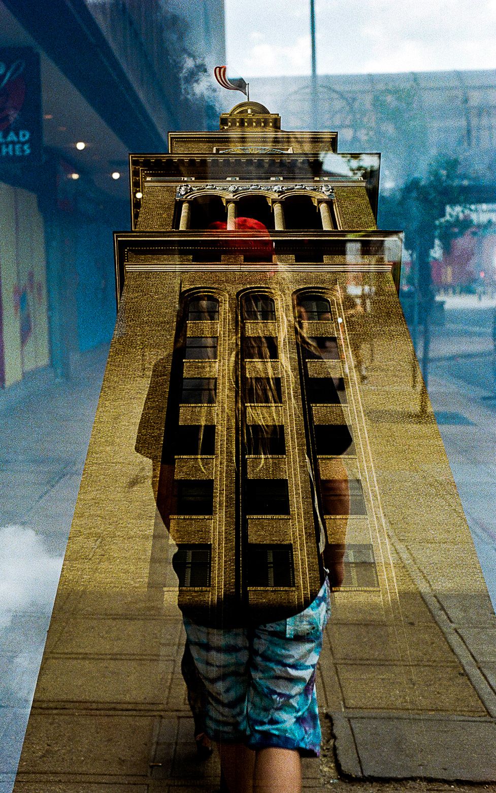 Creative perspective shot of a tall building reflection in an urban setting.