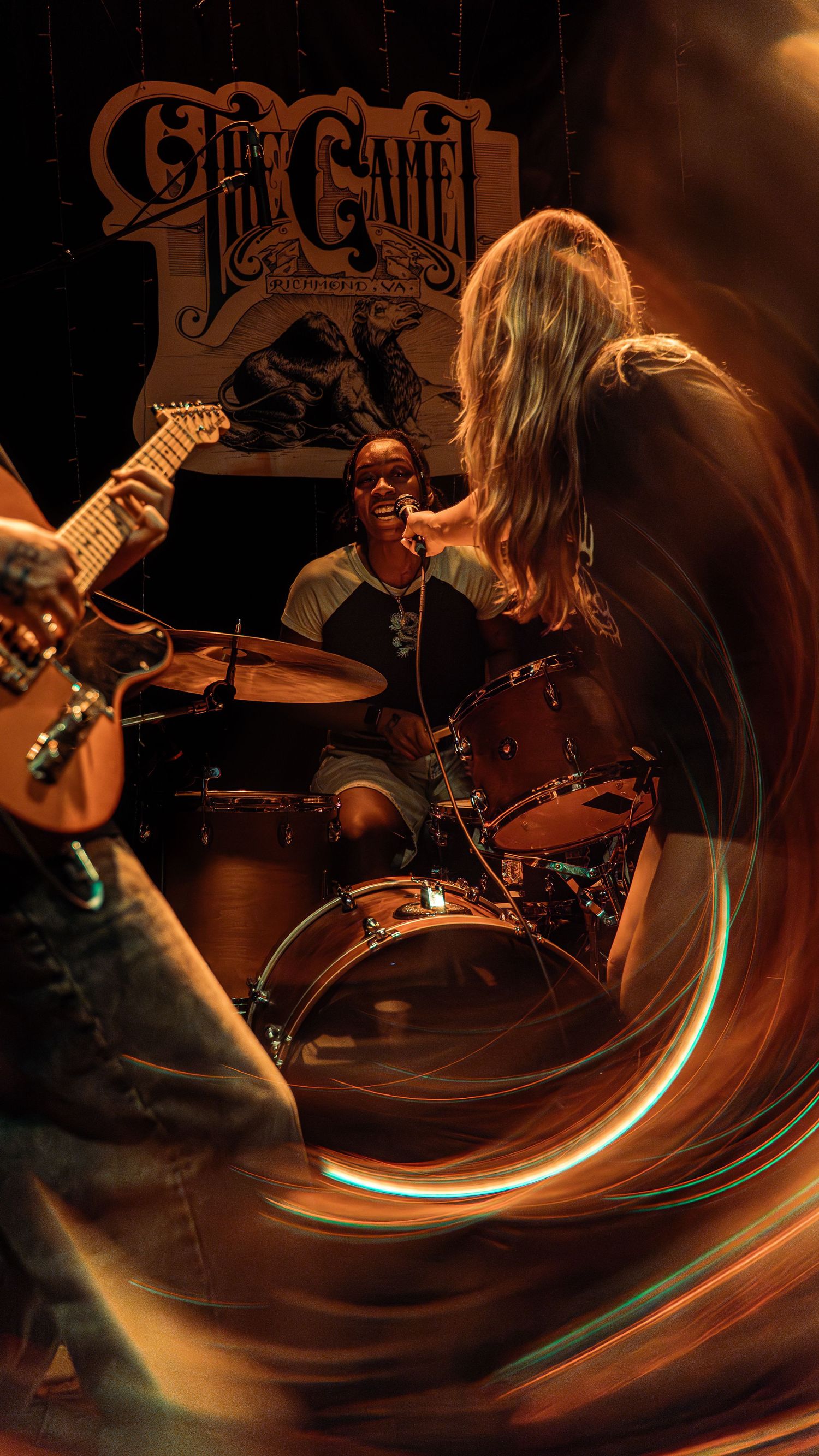 Dynamic concert photography sequence capturing a drummer performing on stage with motion blur and warm ambient lighting effects.