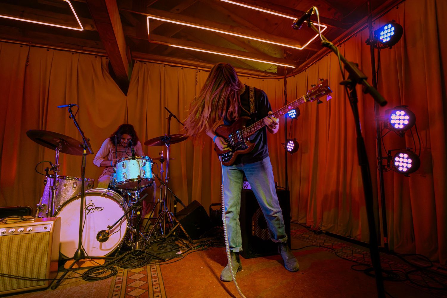 A montage of live band performing on a wooden stage with warm lighting and music equipment.
