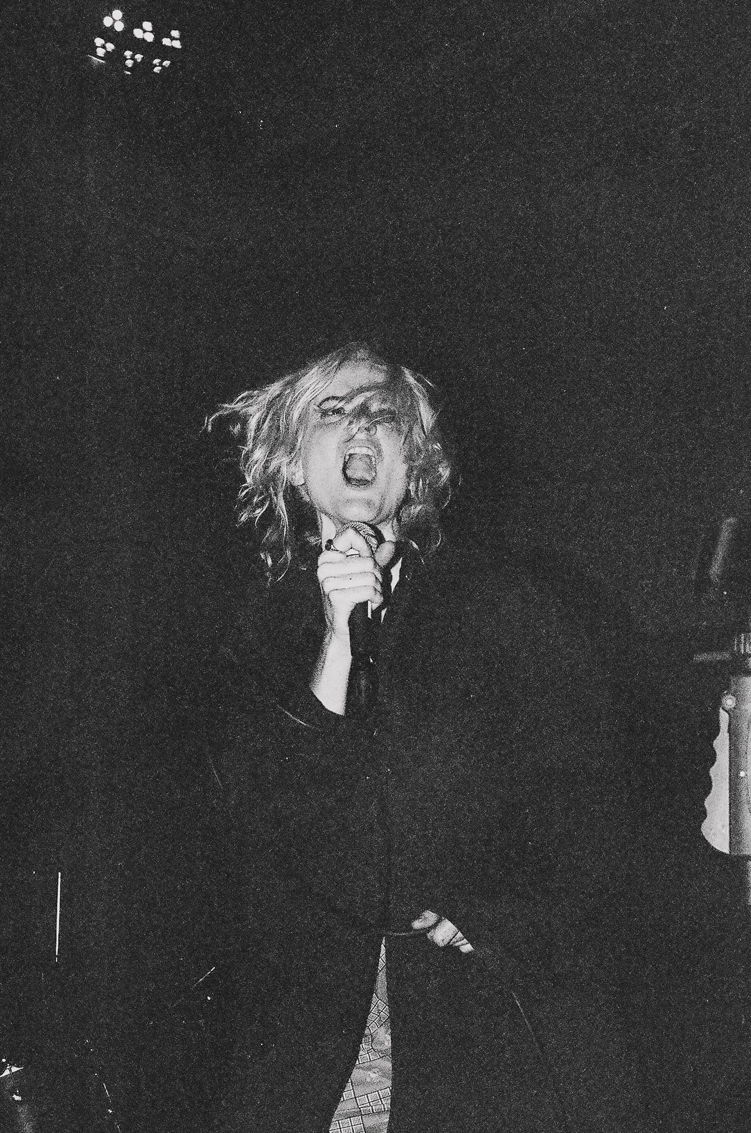 Black and white performance photographs showing dynamic stage movement.