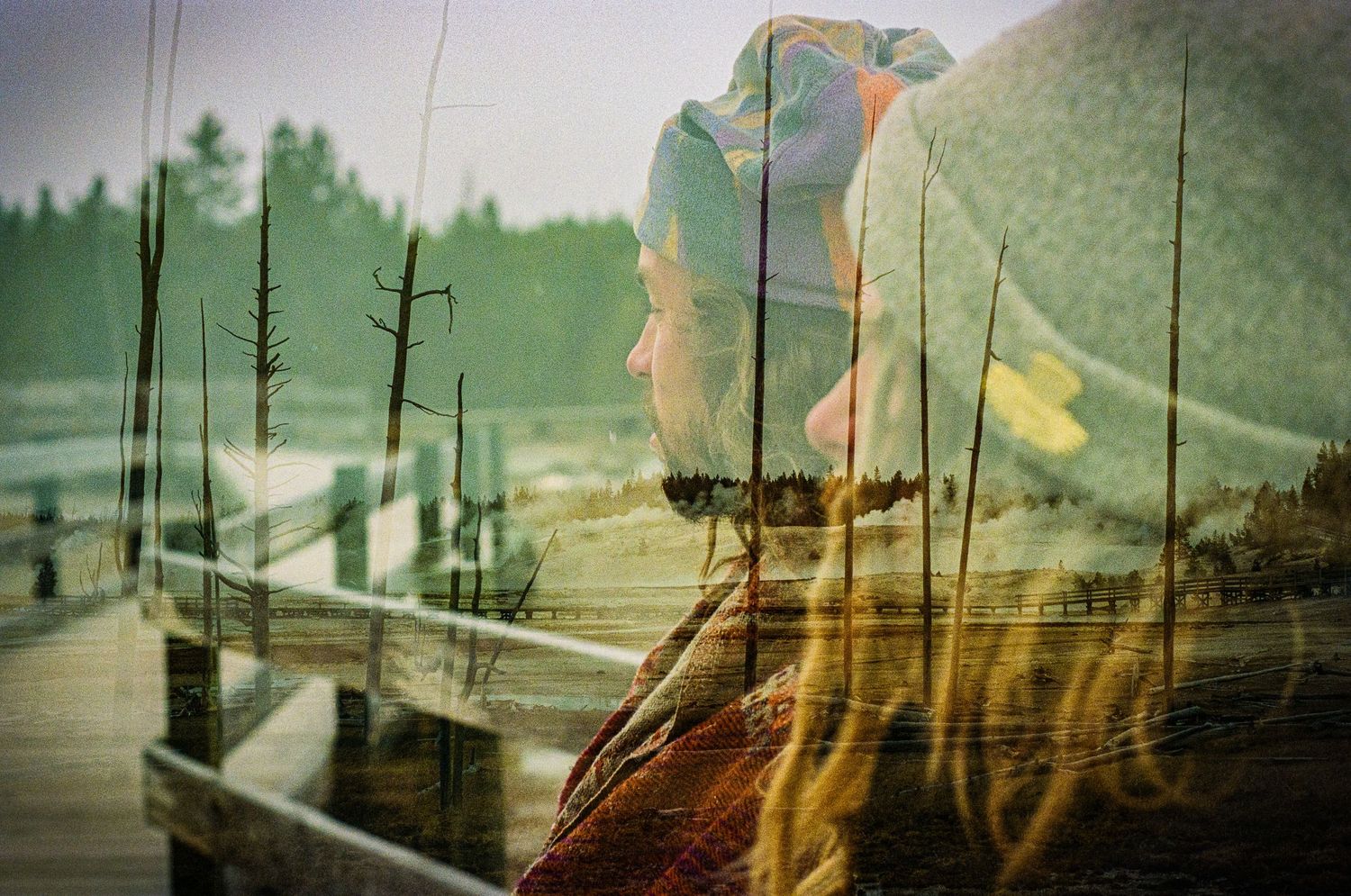 Double exposure photograph showing overlapping green landscapes and silhouettes.