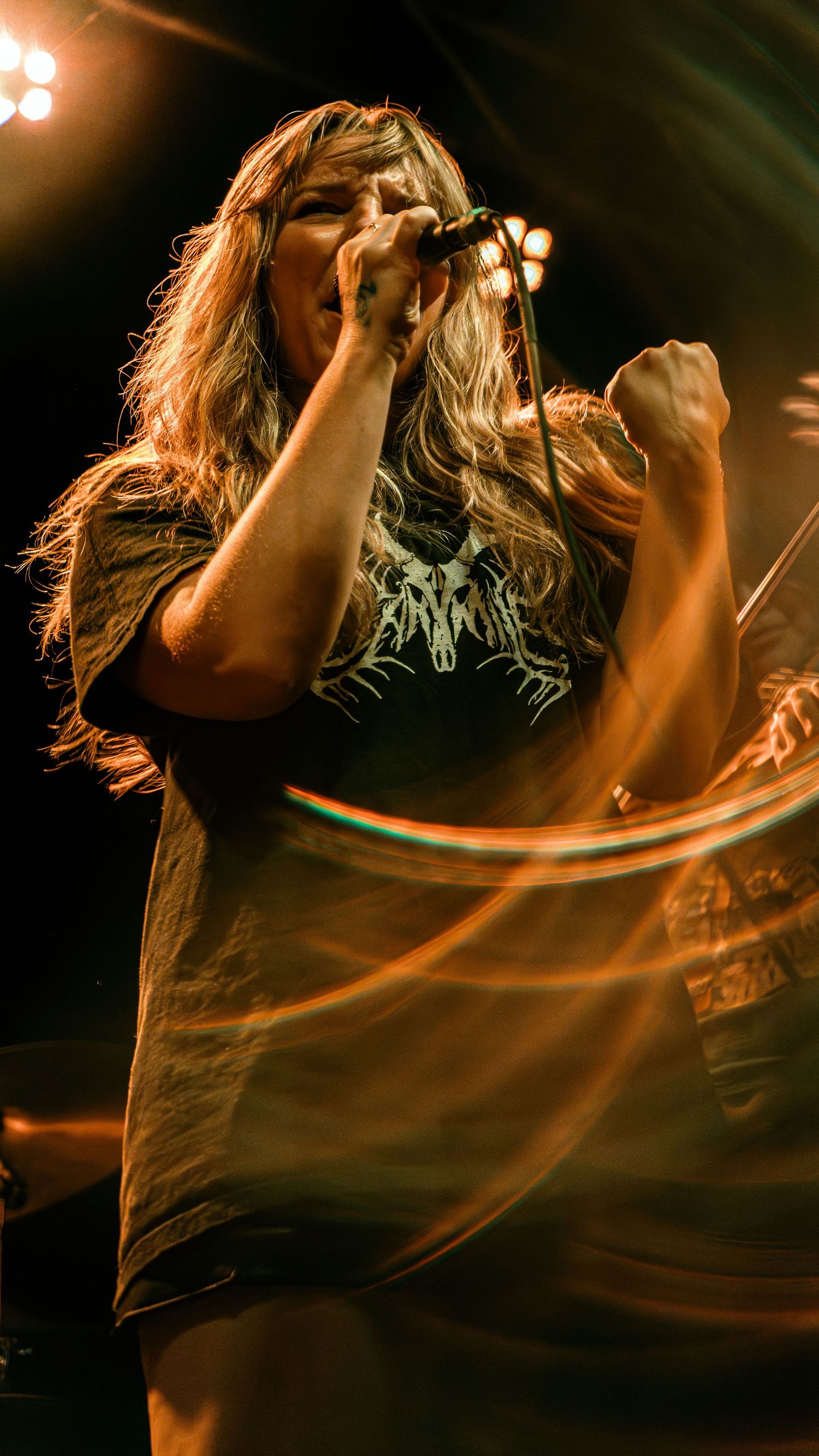Concert performer silhouetted in dramatic orange stage lighting creates dynamic movement across multiple action shots.