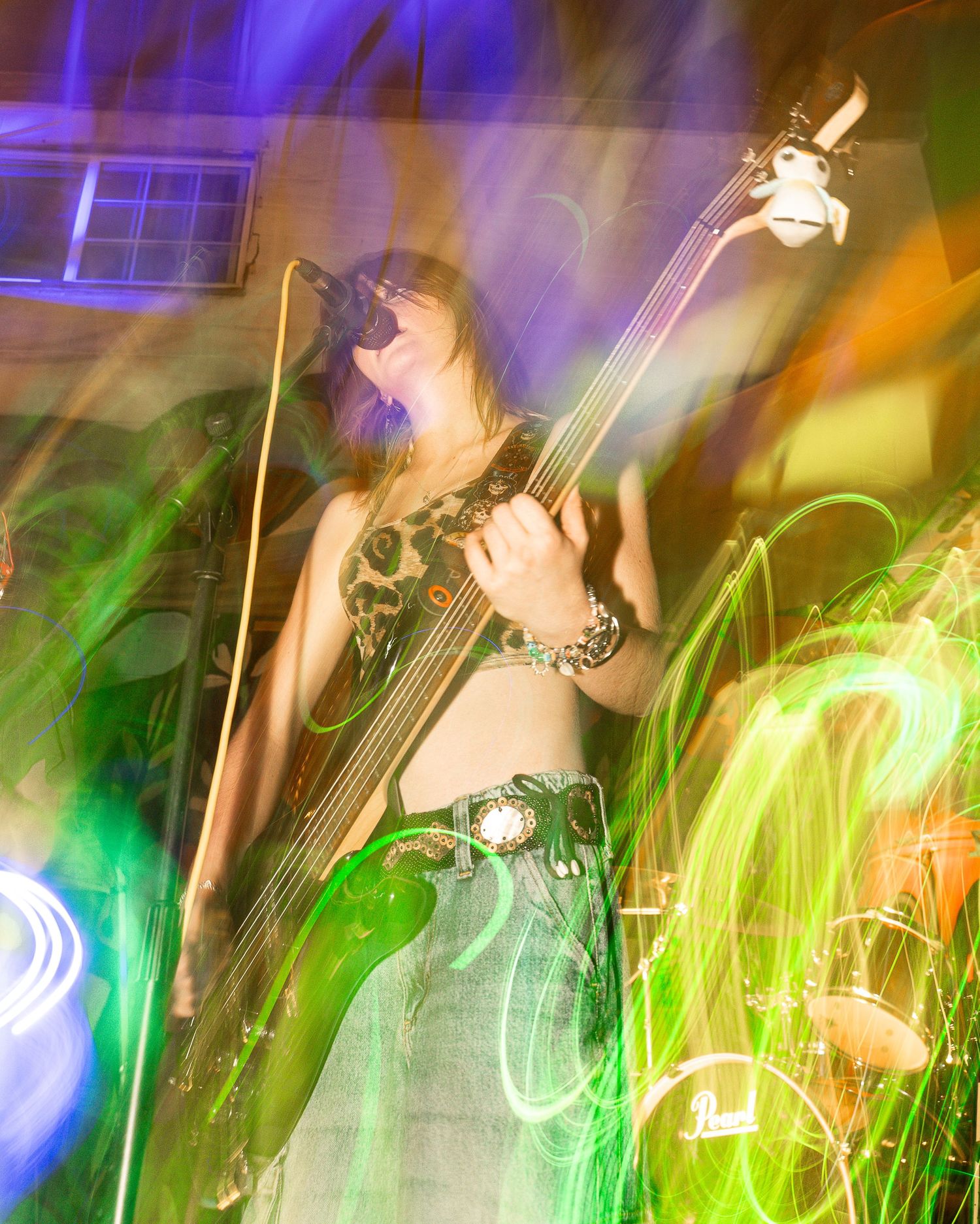 Concert scene with green and purple lighting effects creating dynamic motion trails.
