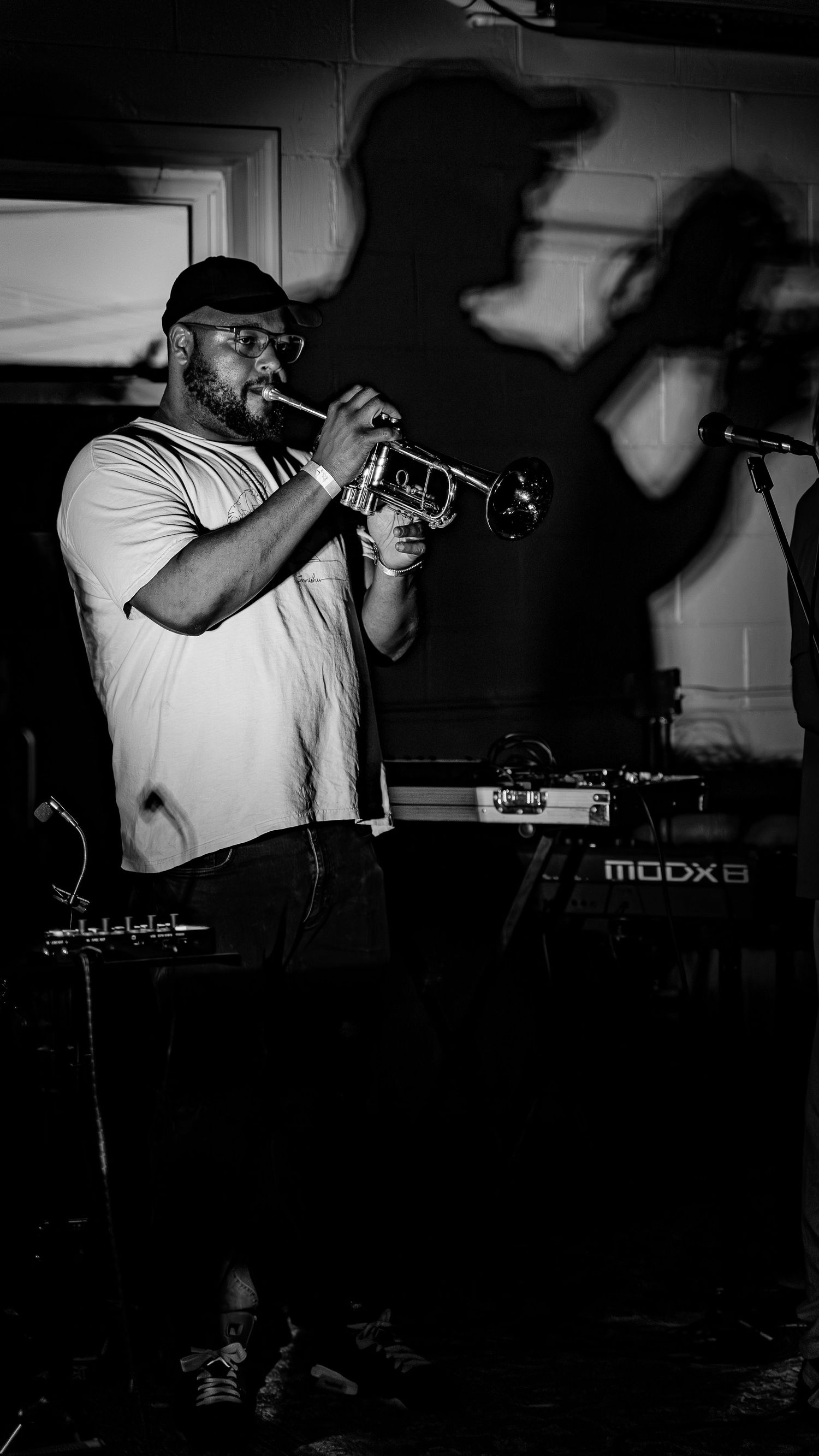 Series of moody black and white shots showing trumpet performer in action.