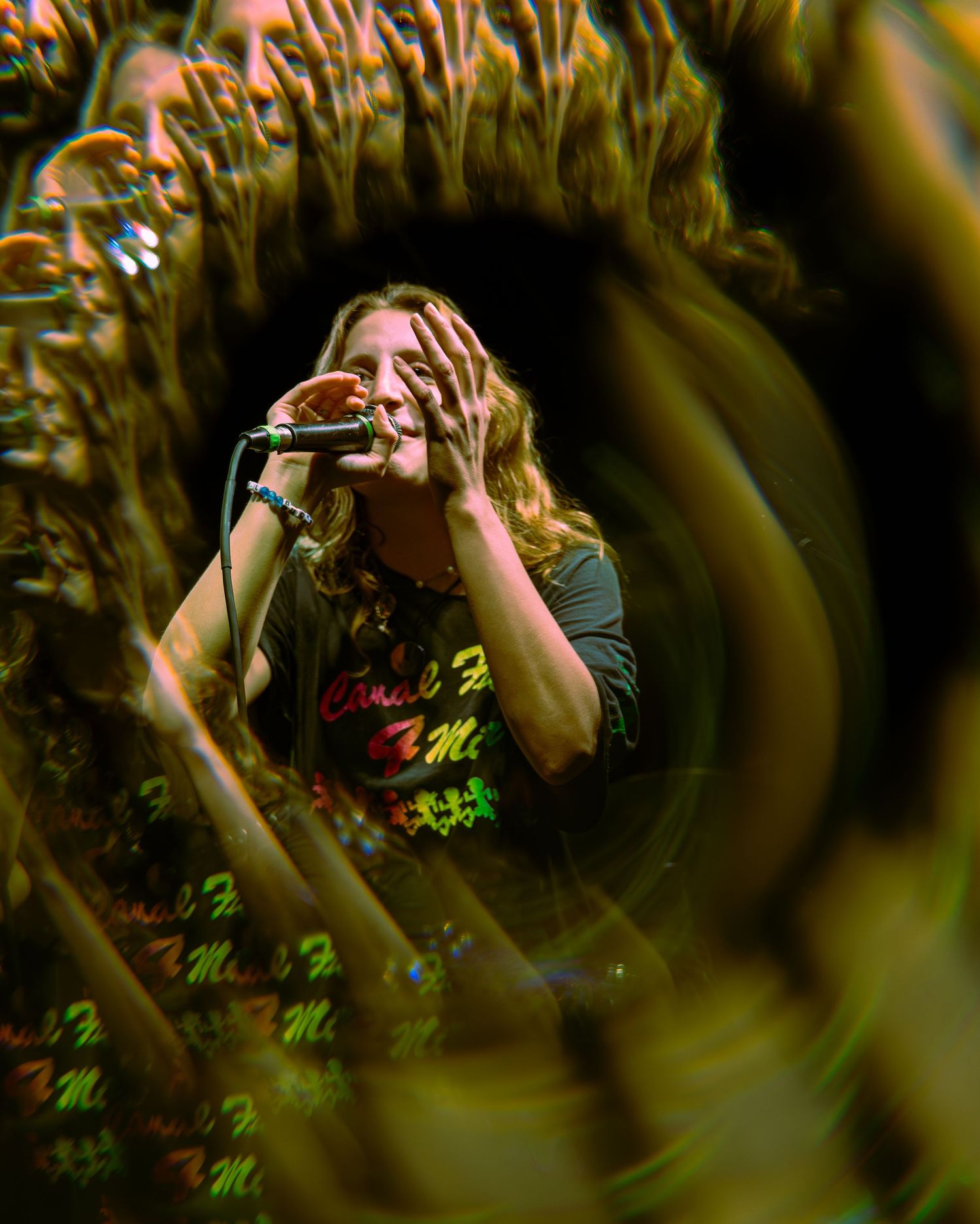 Multiple photos showing a person making zoom gestures through palm fronds, creating a natural frame effect.