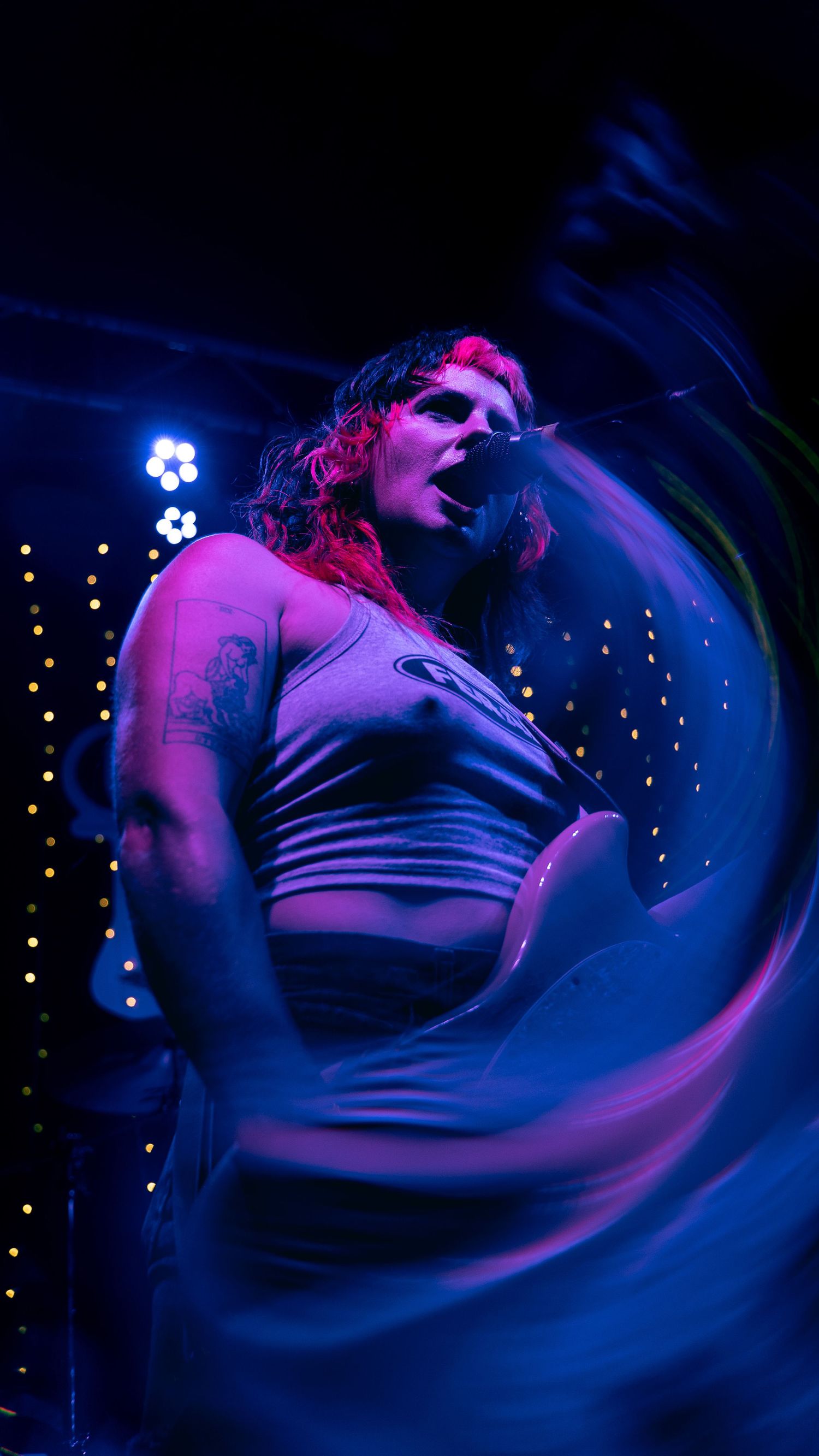 A dark moody portrait sequence in purple and blue lighting shows dynamic movement and dramatic angles.
