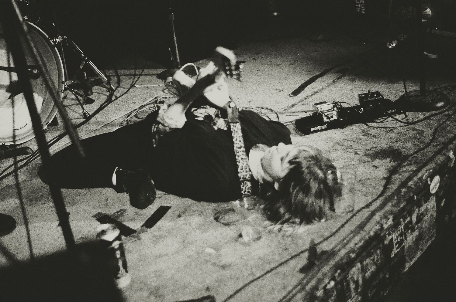 Vintage black and white photo of performers on stage during an intense live music moment.