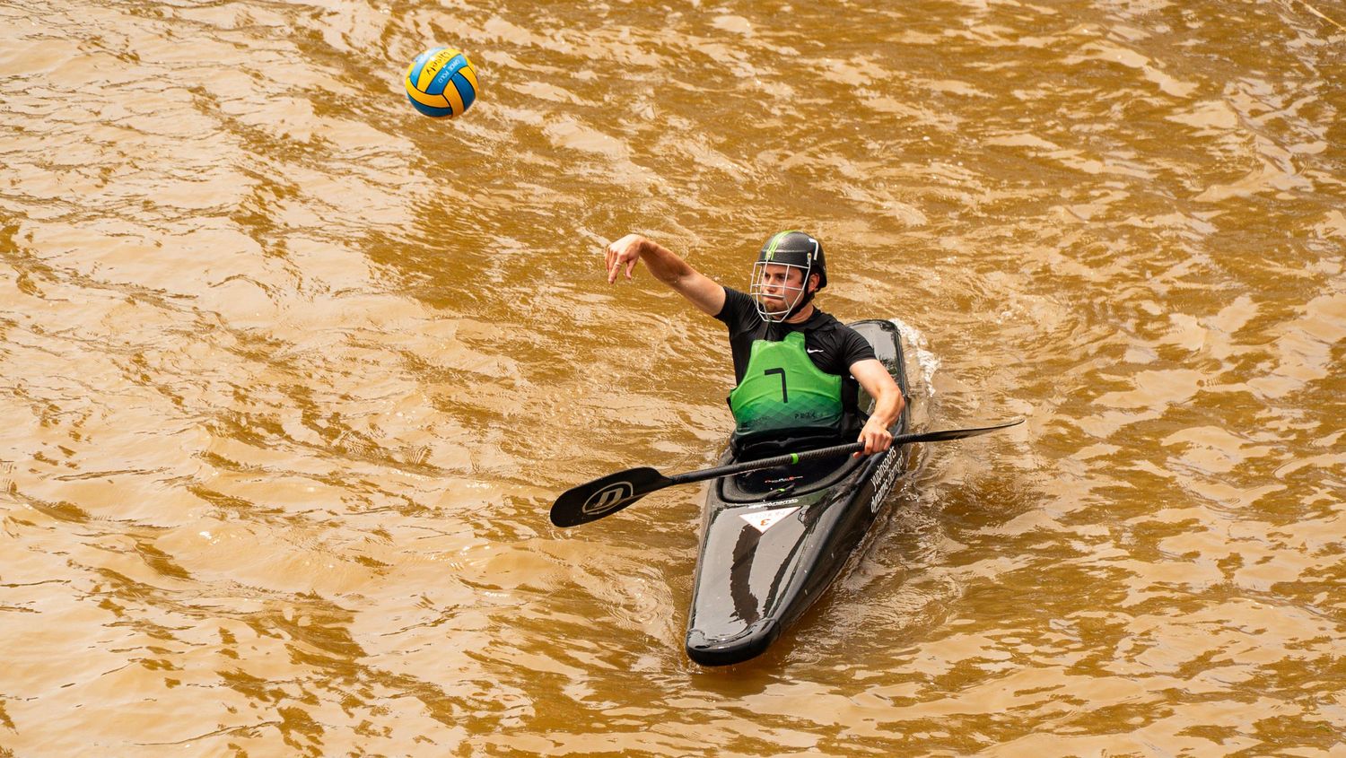 Participants navigate muddy obstacle course during intense outdoor competition.