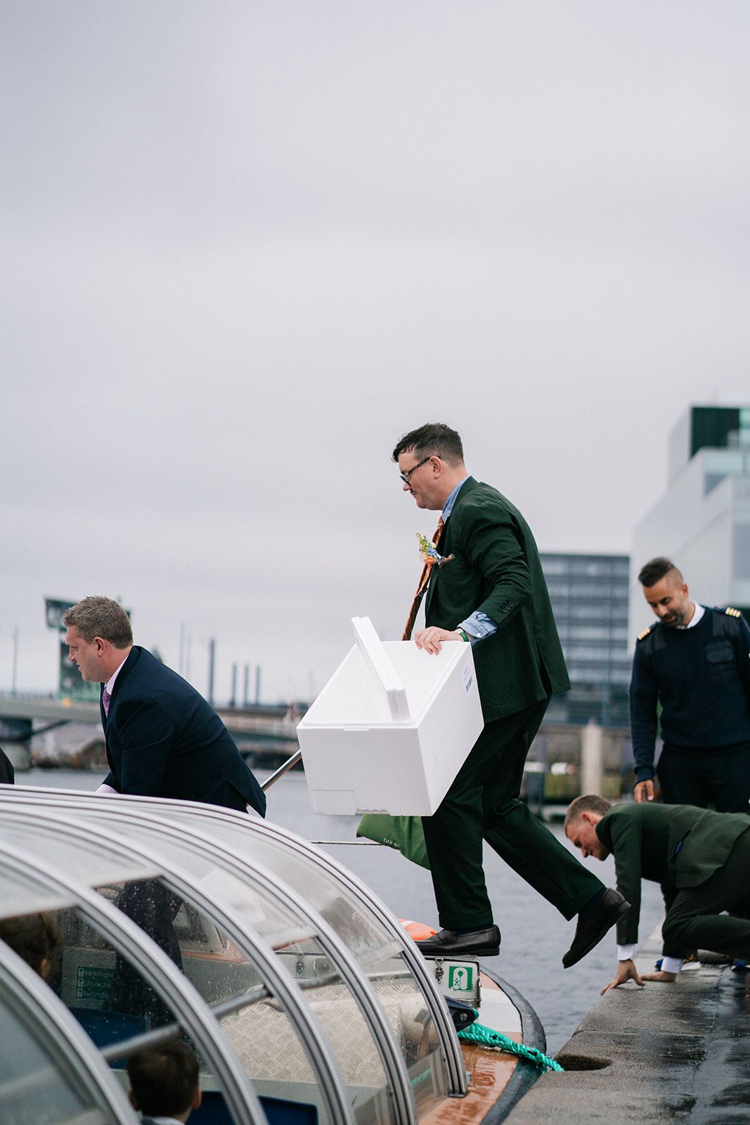 A sequence of motion shots showing people leaping over silver cars on an overcast day.