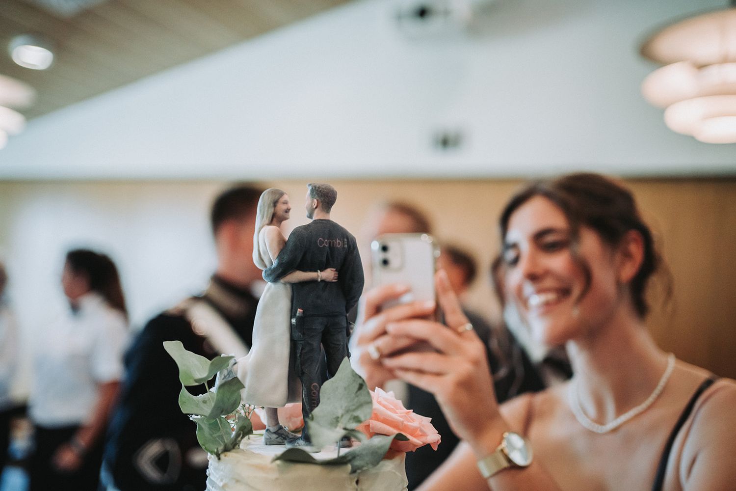 Elegant wedding couple shares an intimate first dance surrounded by guests at their reception celebration.