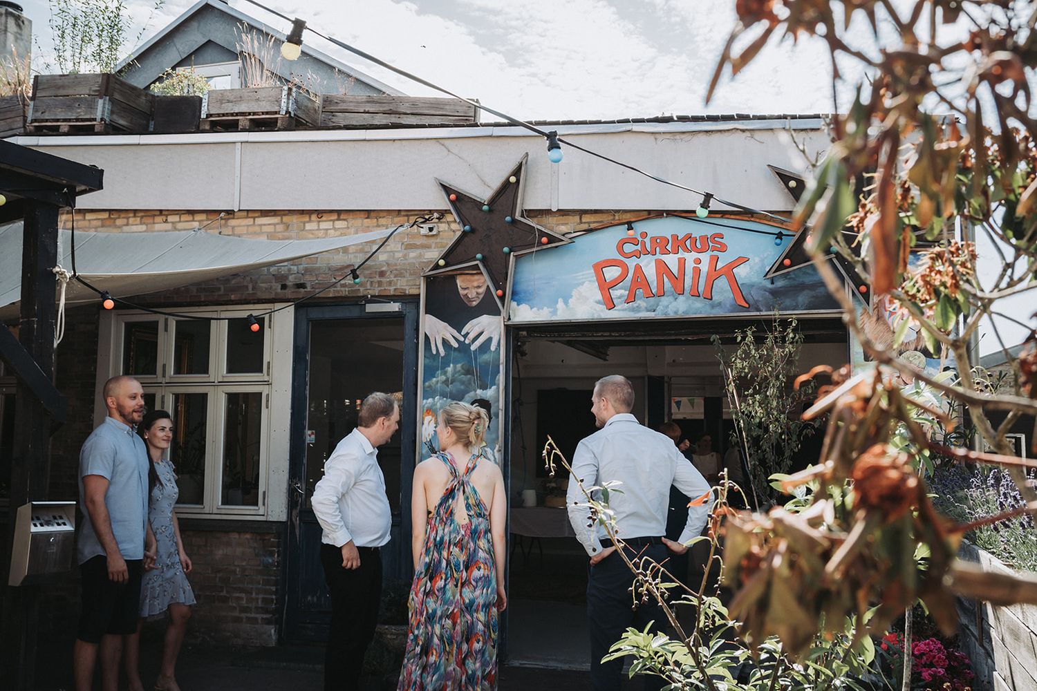 Autumn outdoor wedding venue with rustic wooden structures and natural fall decor.