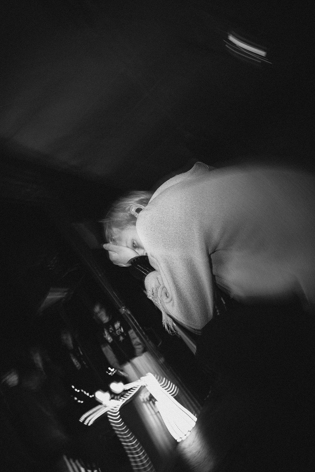 Dramatic black and white shot of a performer diving into a crowd during an energetic punk rock show.