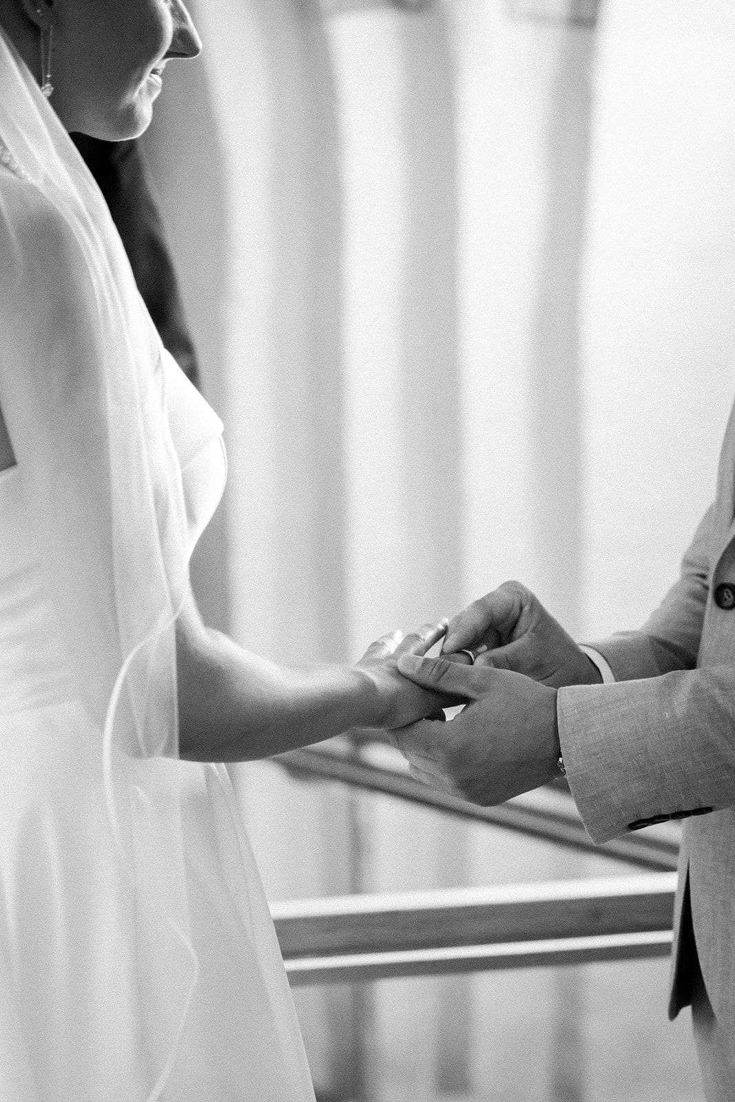 A close-up of two hands interacting showing a client and professional having a business discussion at a desk.