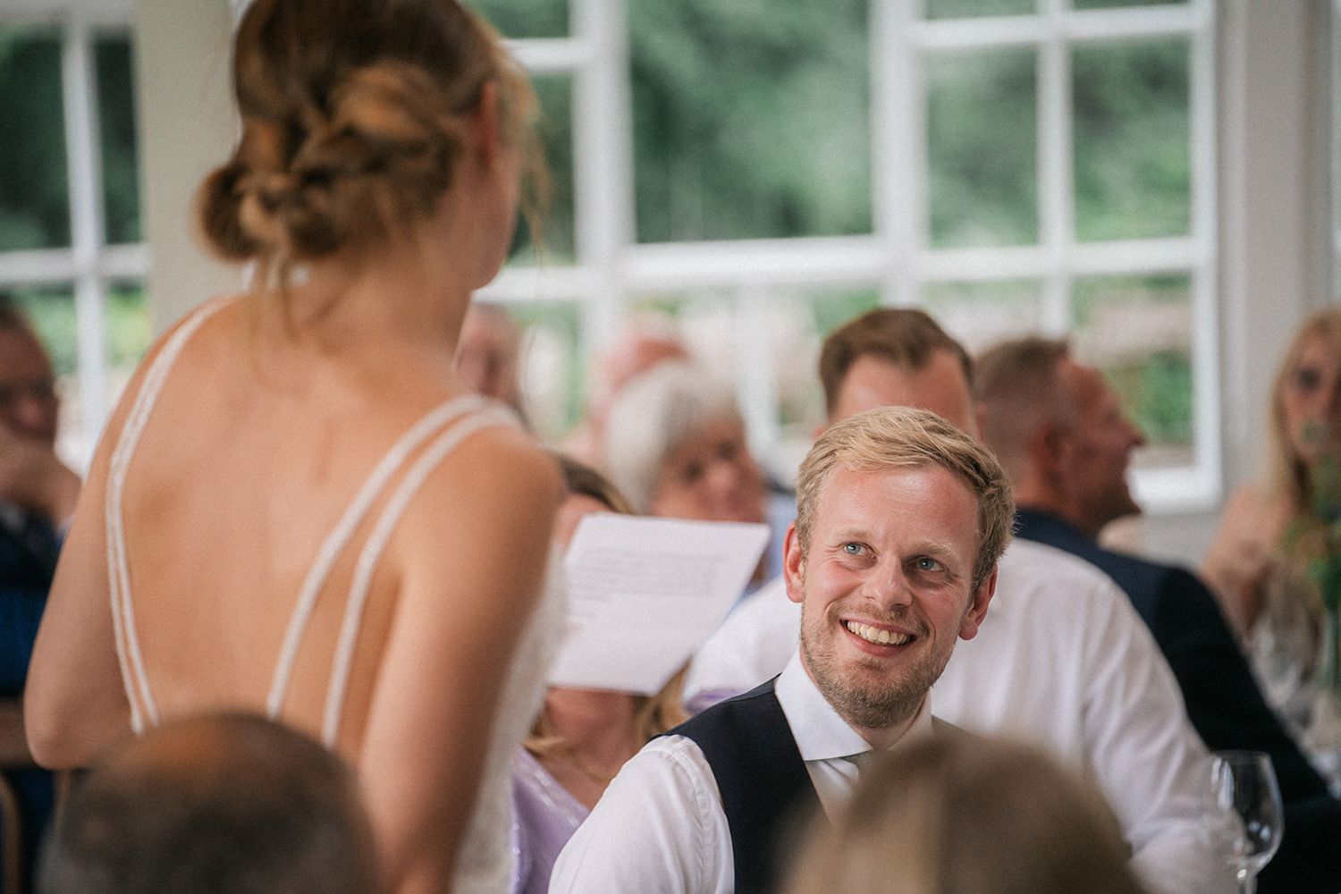 Wedding reception guests enjoying a festive moment together at an indoor celebration.