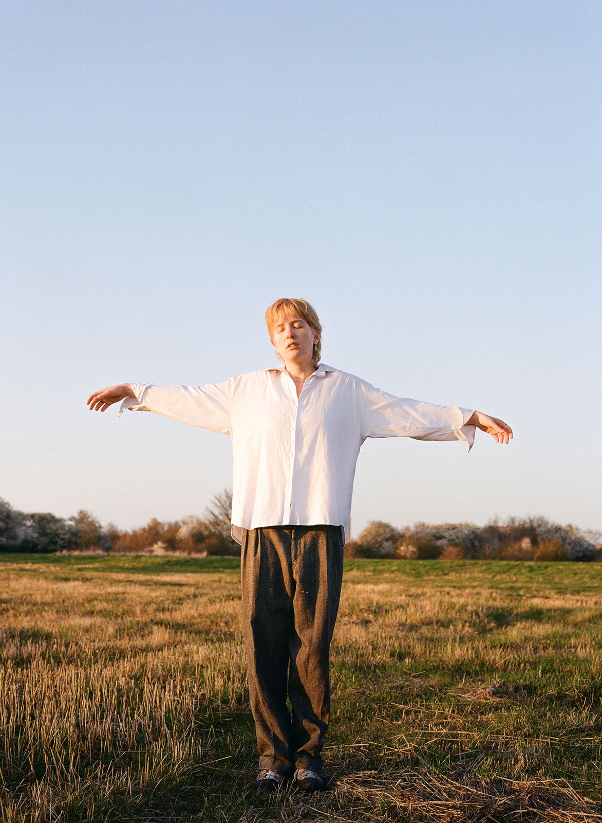 Minimalist triptych series of someone standing in a golden field at sunset casting dramatic shadows.
