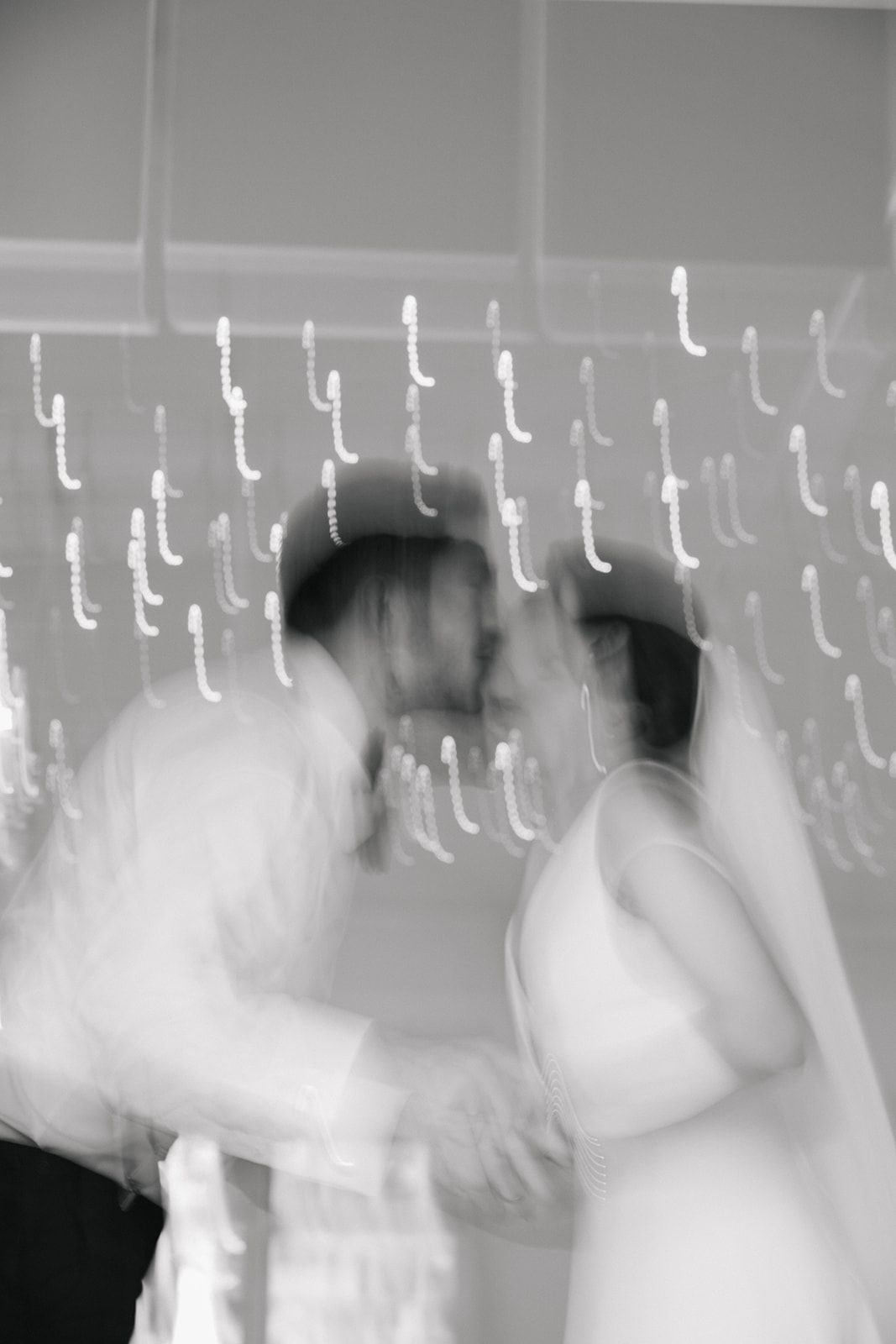 Abstract black and white motion blur of dancers at a celebration.
