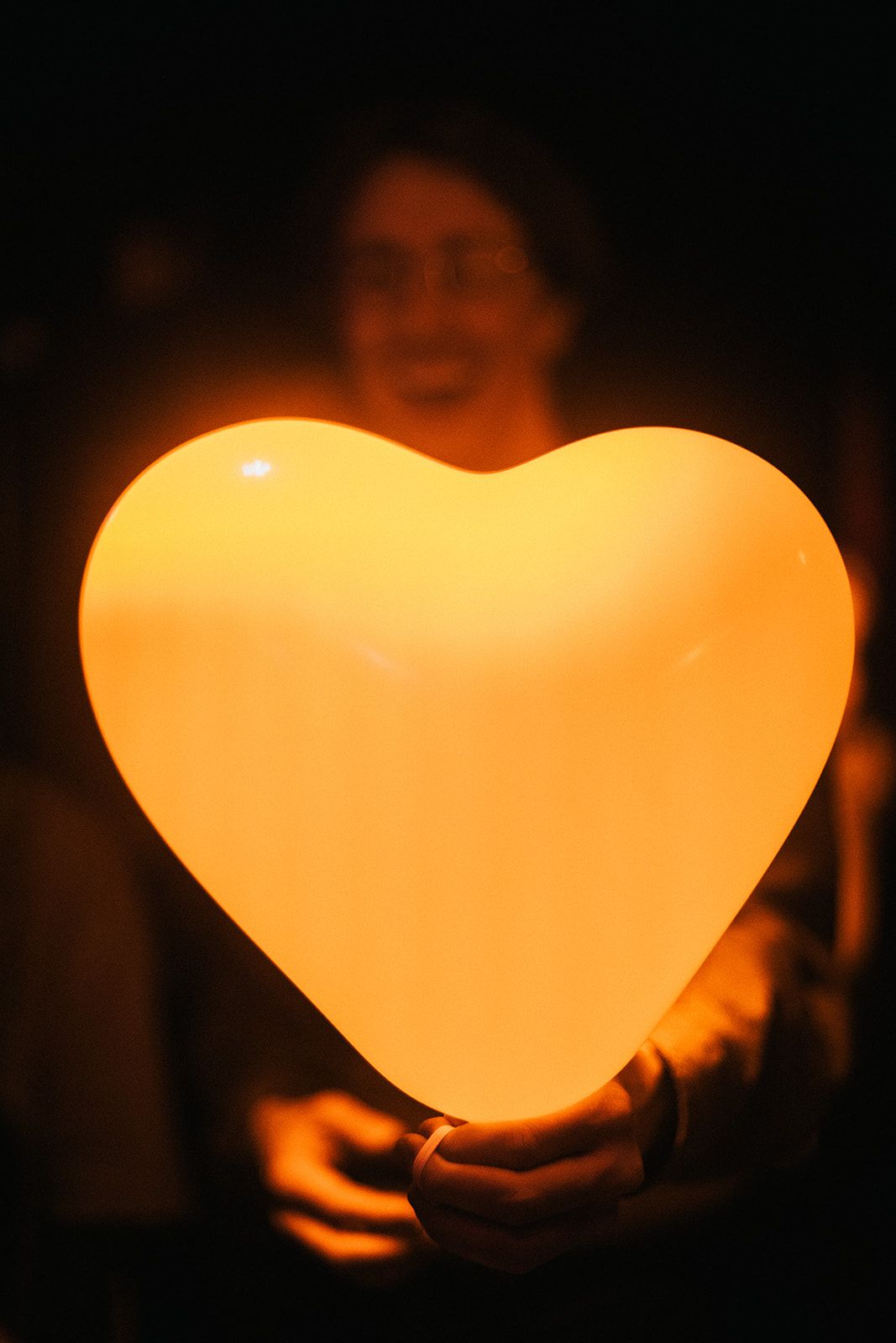 Heart-shaped glowing lanterns illuminated against a dark background creating a warm ambiance.