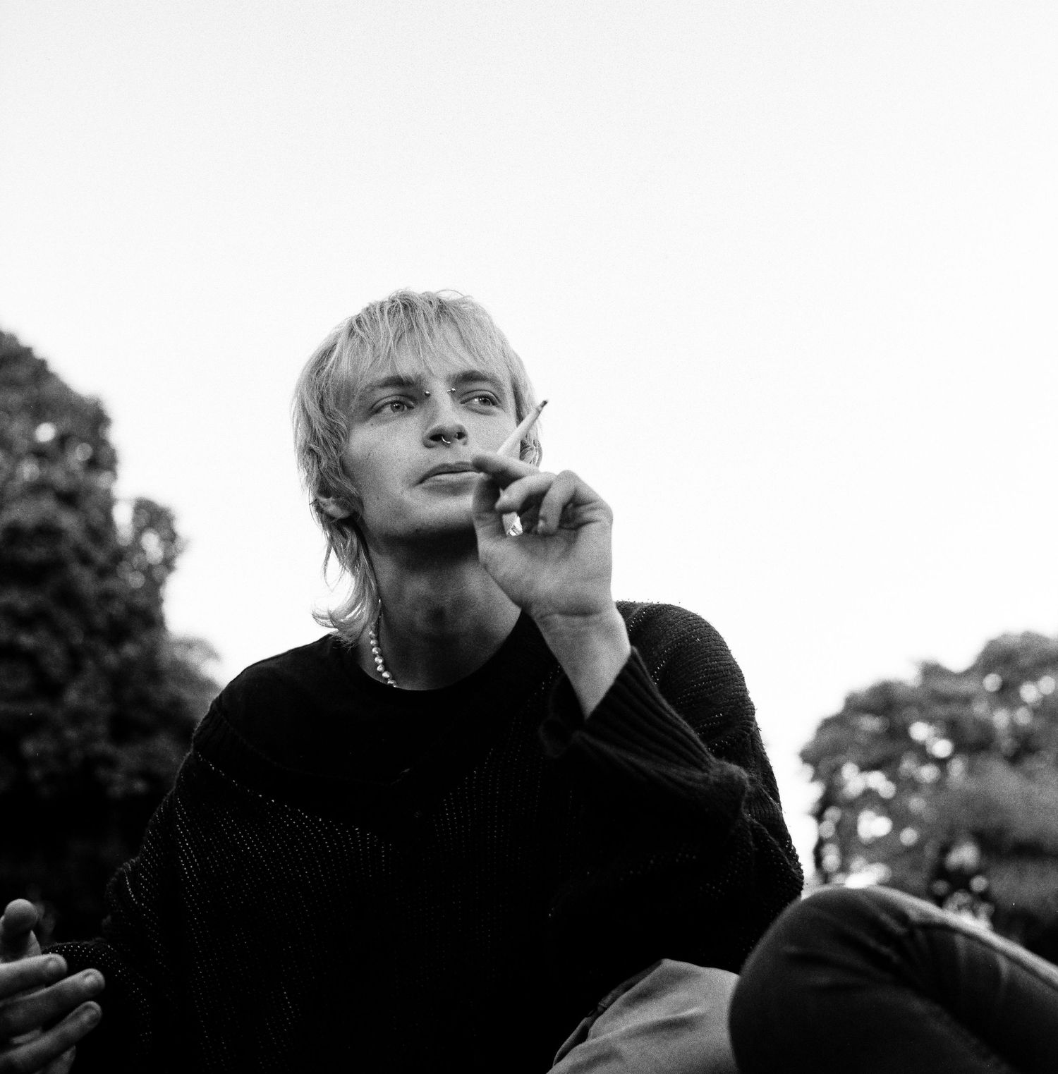 Black and white portraits in a series showing contemplative moments with dramatic lighting and shadows.