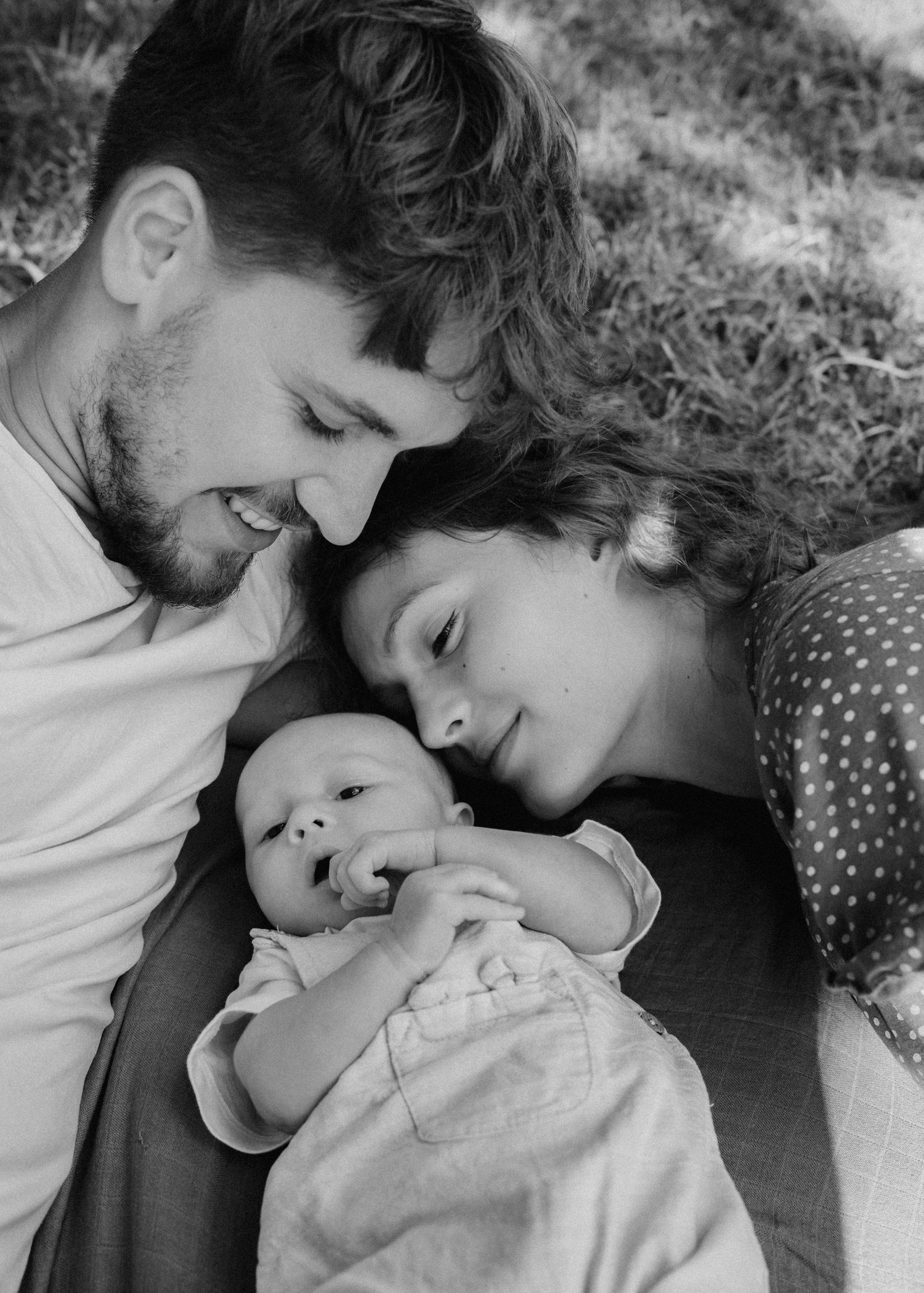 Black and white series of tender family moments captured in natural light.