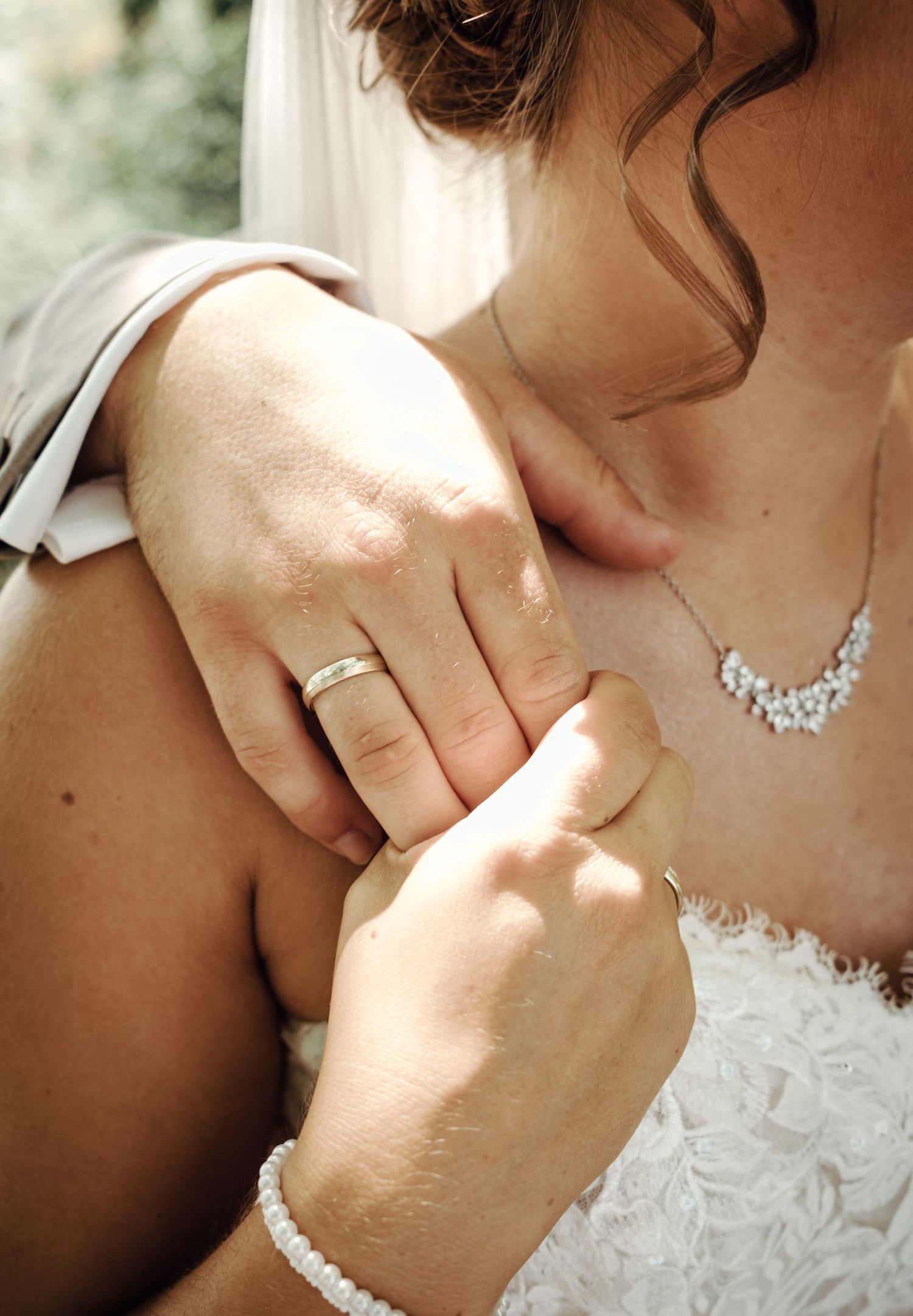 Close-up shots of bridal jewelry and delicate details on a white wedding dress in natural light.