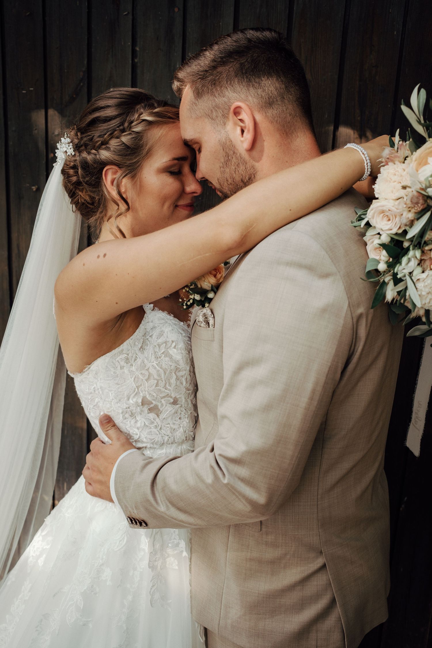 Wedding couple shares intimate moments in a series of romantic poses against a dark background.